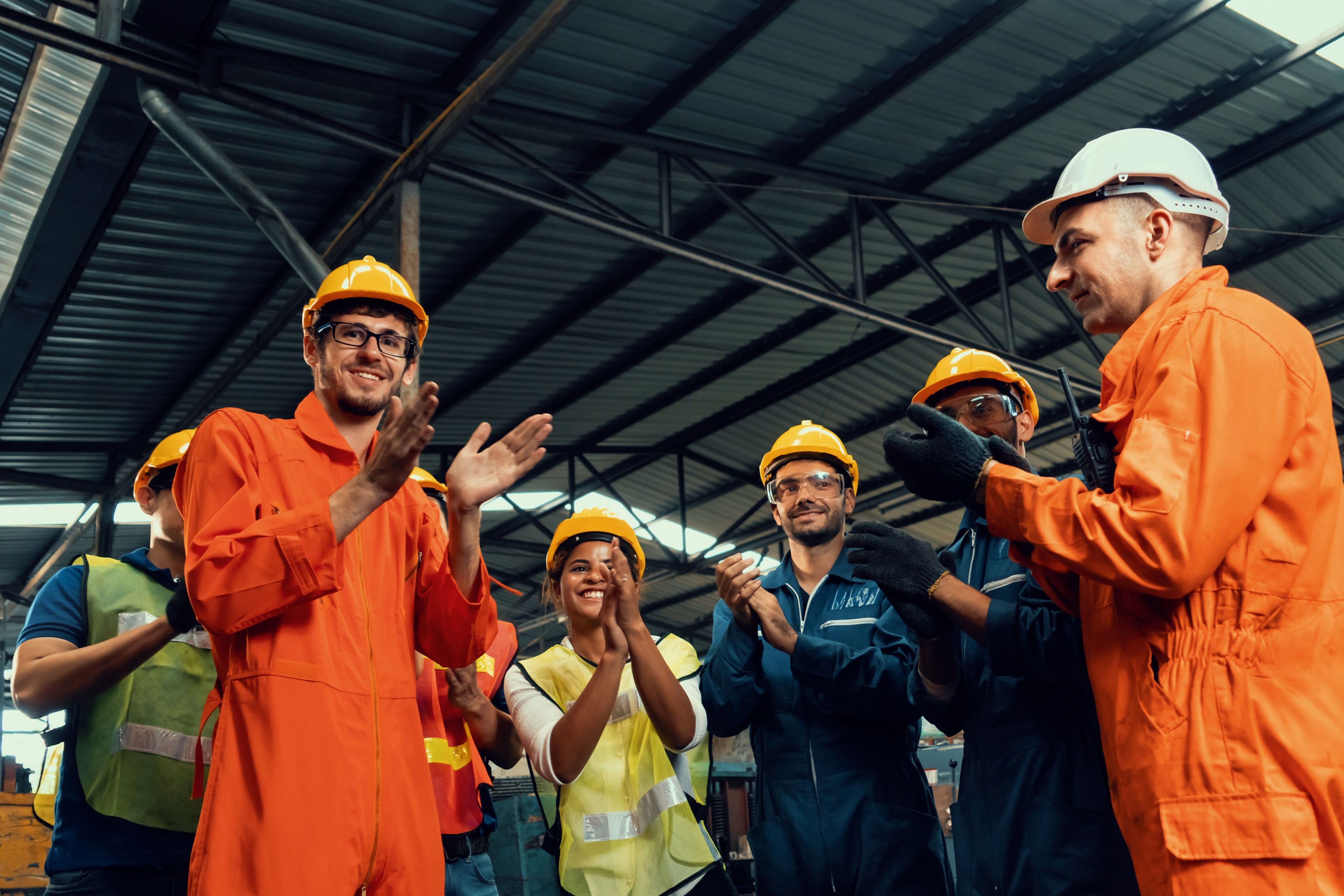 Skillful worker celebrate success in the factory