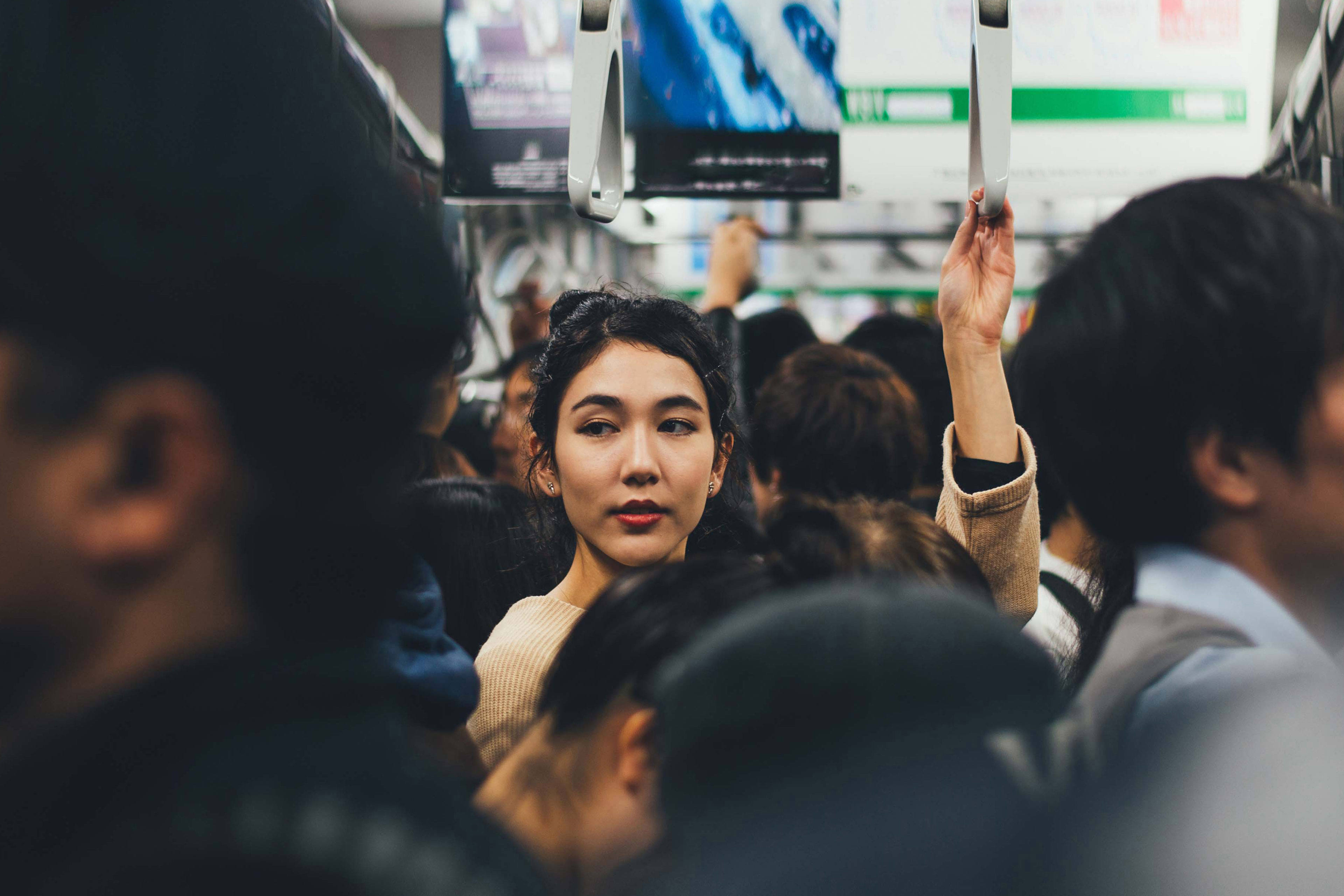 Woman holding subway handle