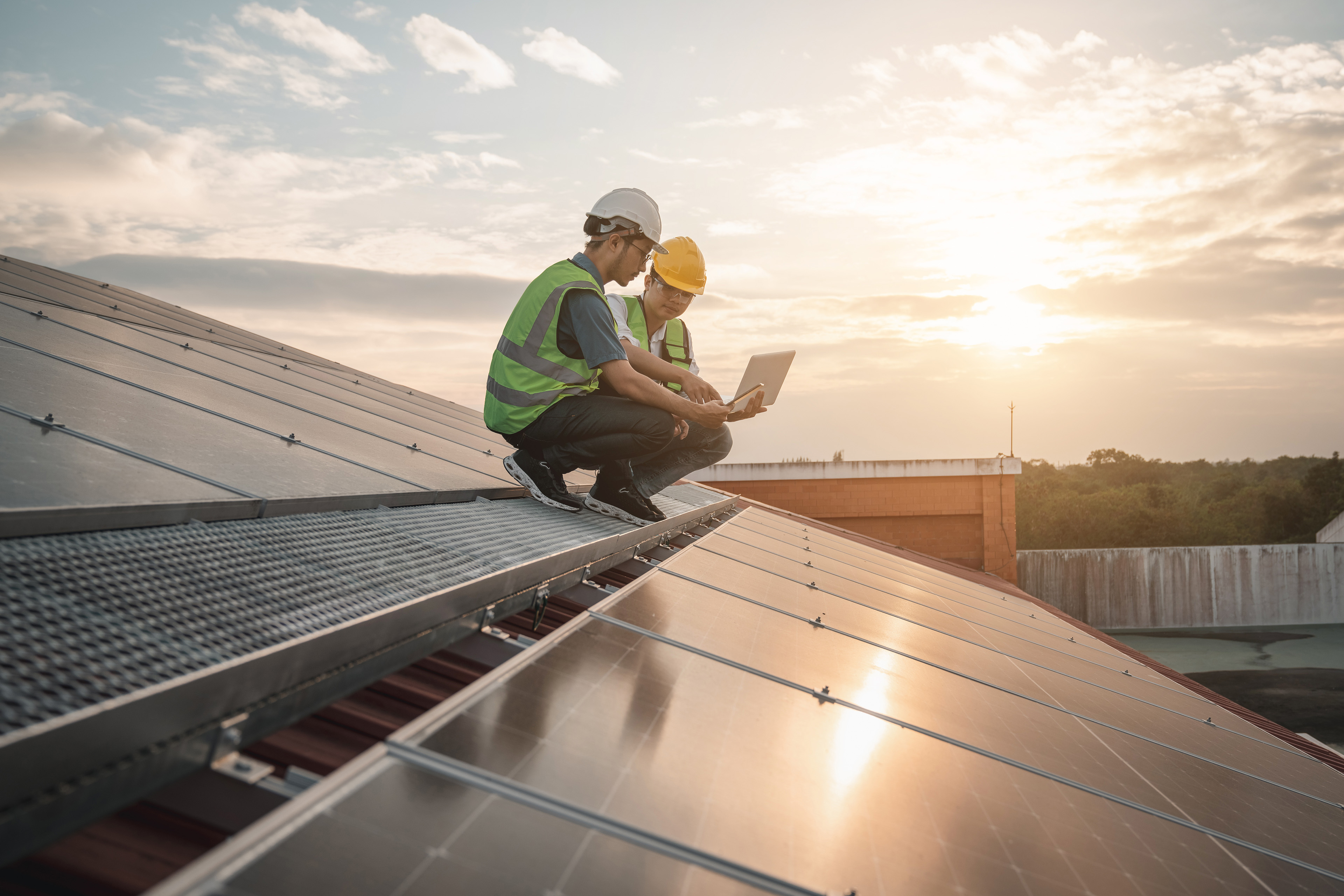 Service engineer checking solar cell on the roof for maintenance if there is a damaged part.