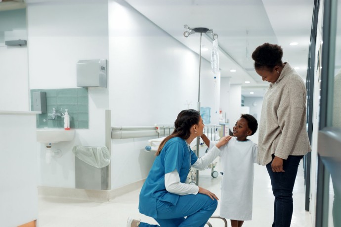 Doctor talking to a patient in the hospital for medical child care