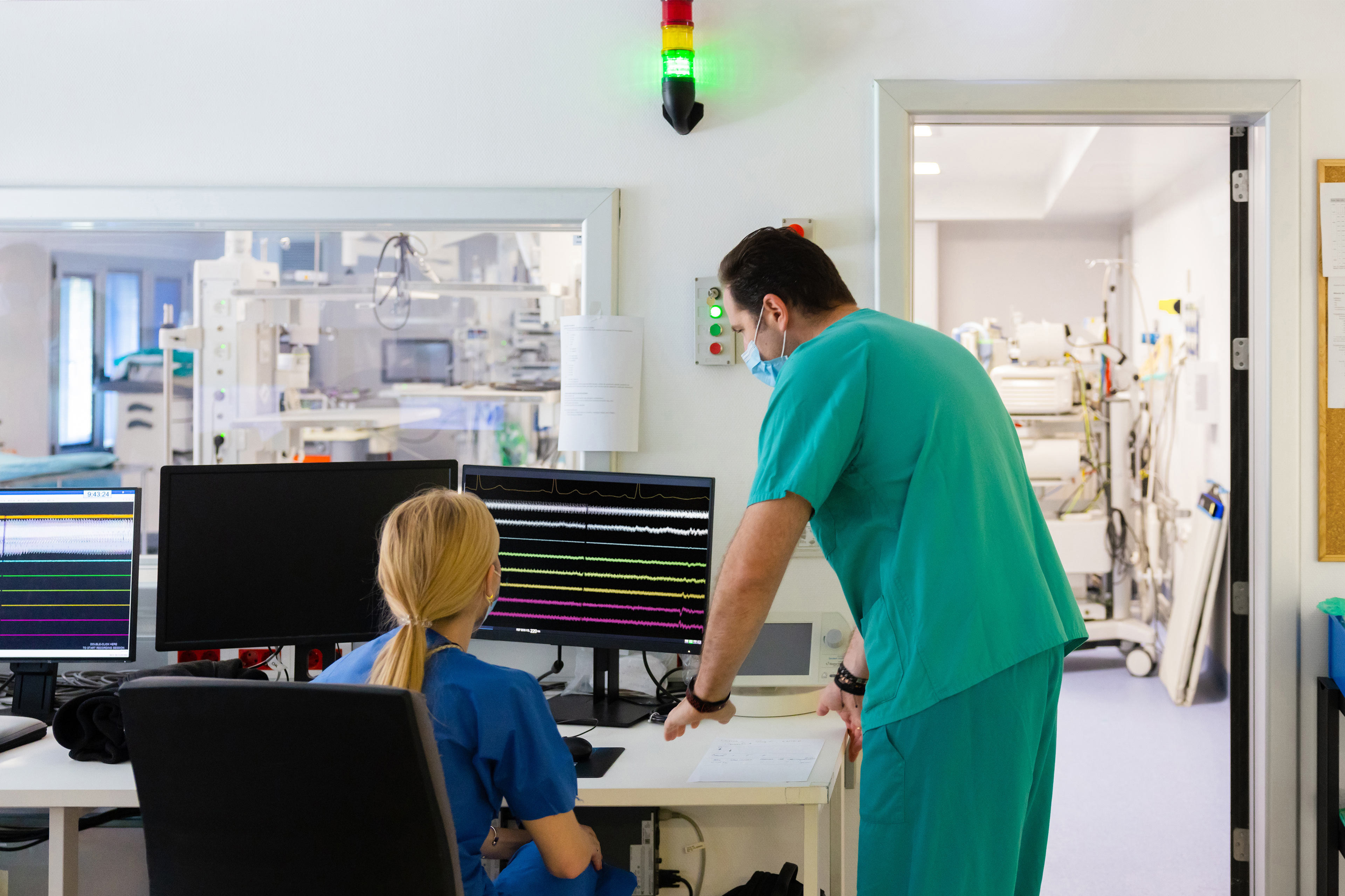 Electrophysiologist checking data on monitor