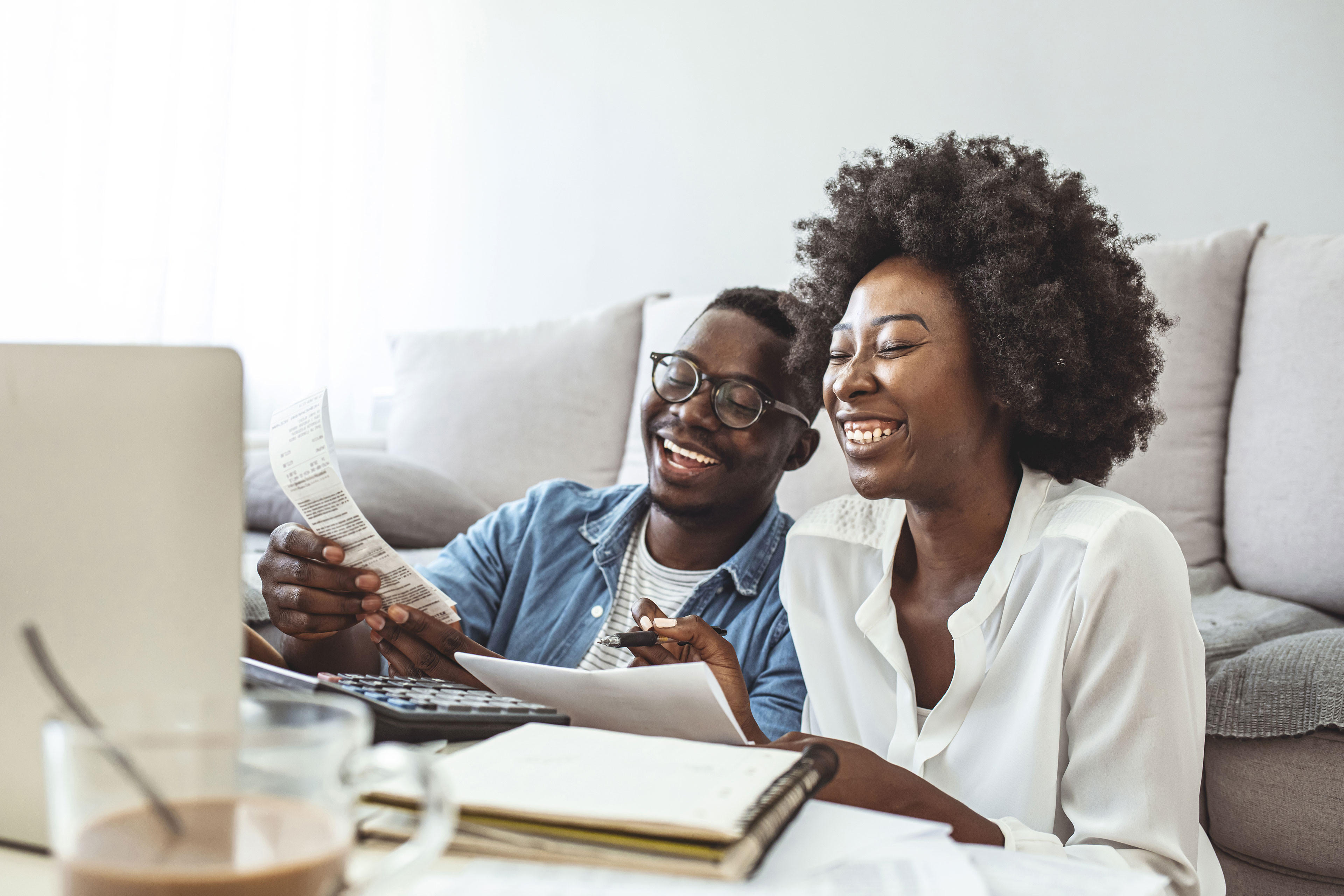 Happy couple paying bills