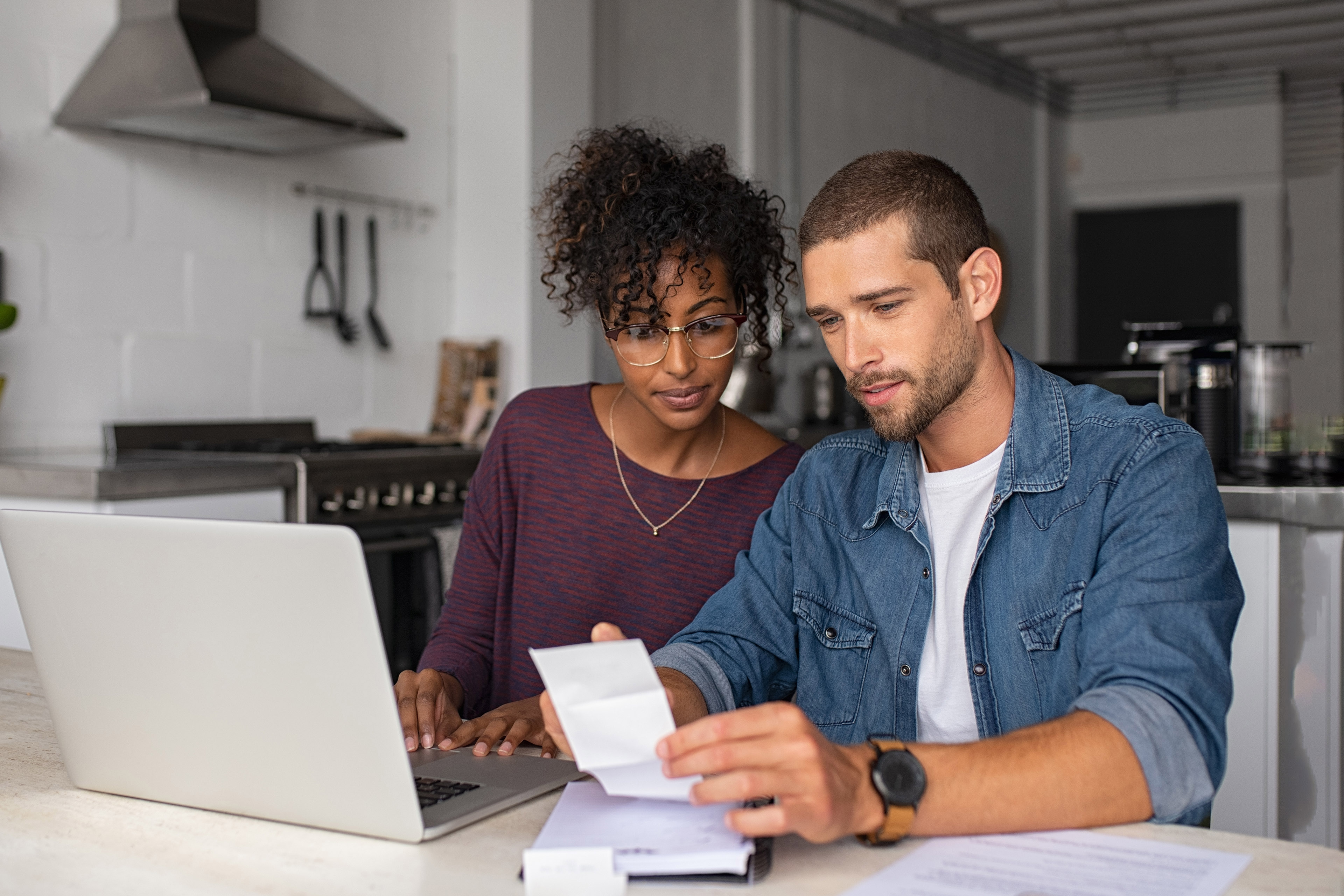 Young couple examining home finance