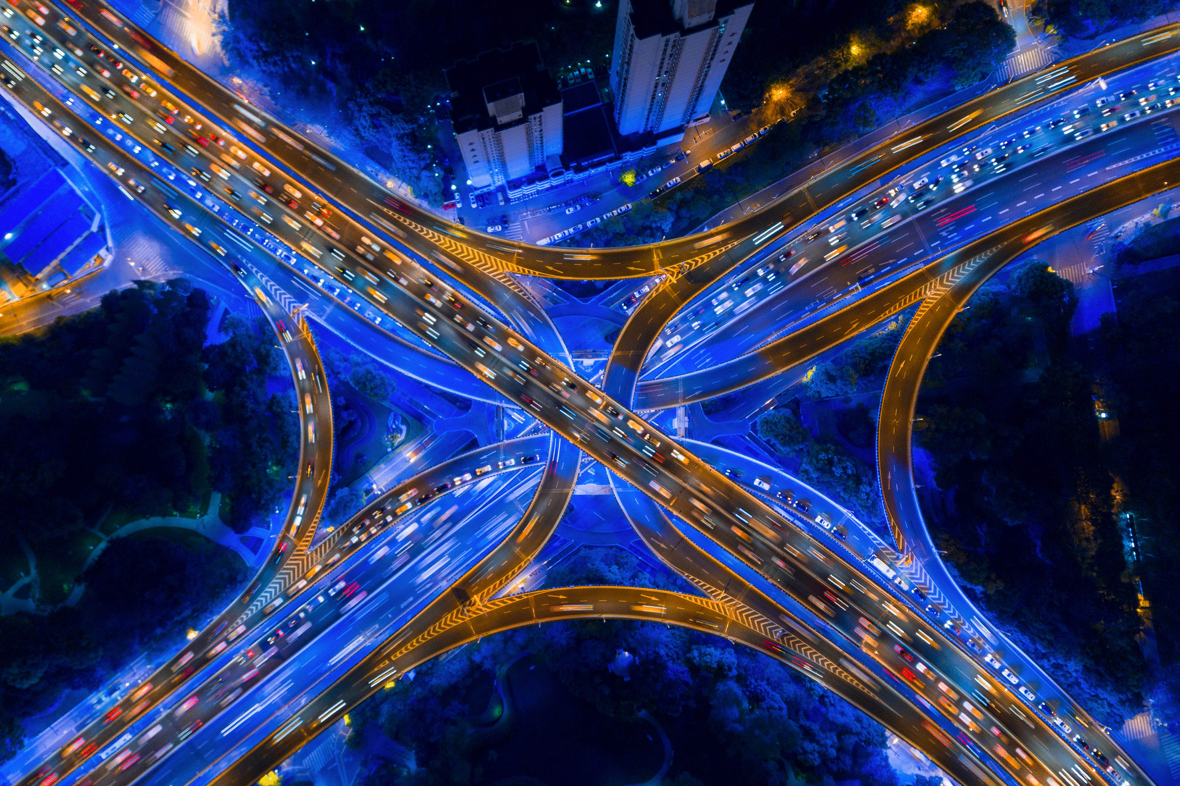 Aerial view of highway junctions shape letter x cross at night.