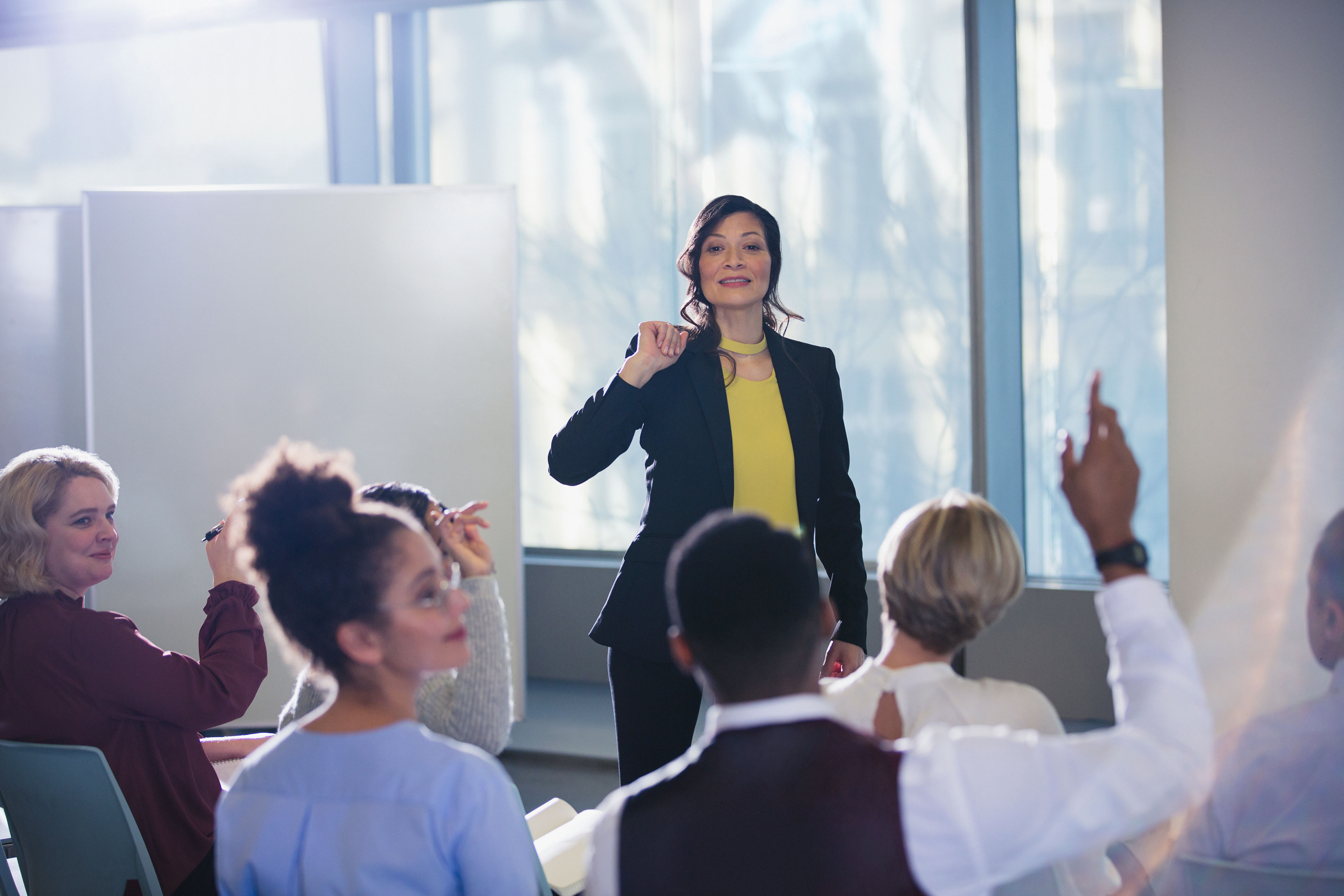 ey businesswoman leading meeting answering audience