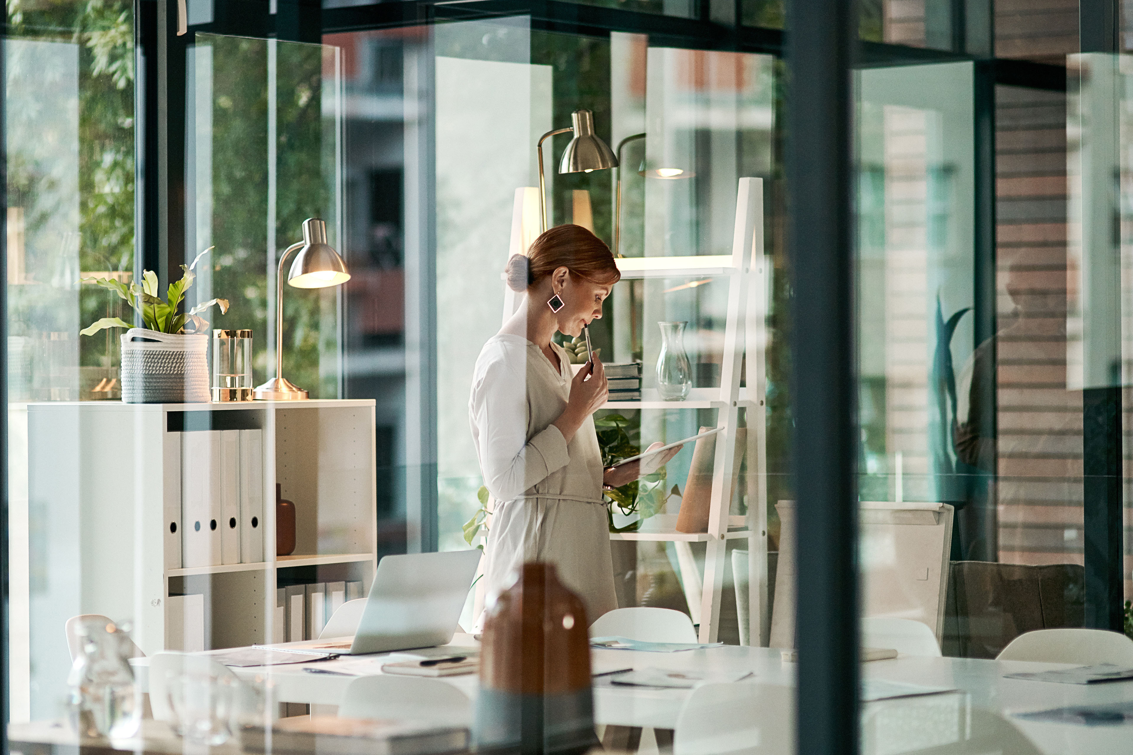 A businesswoman doing online research on a tablet