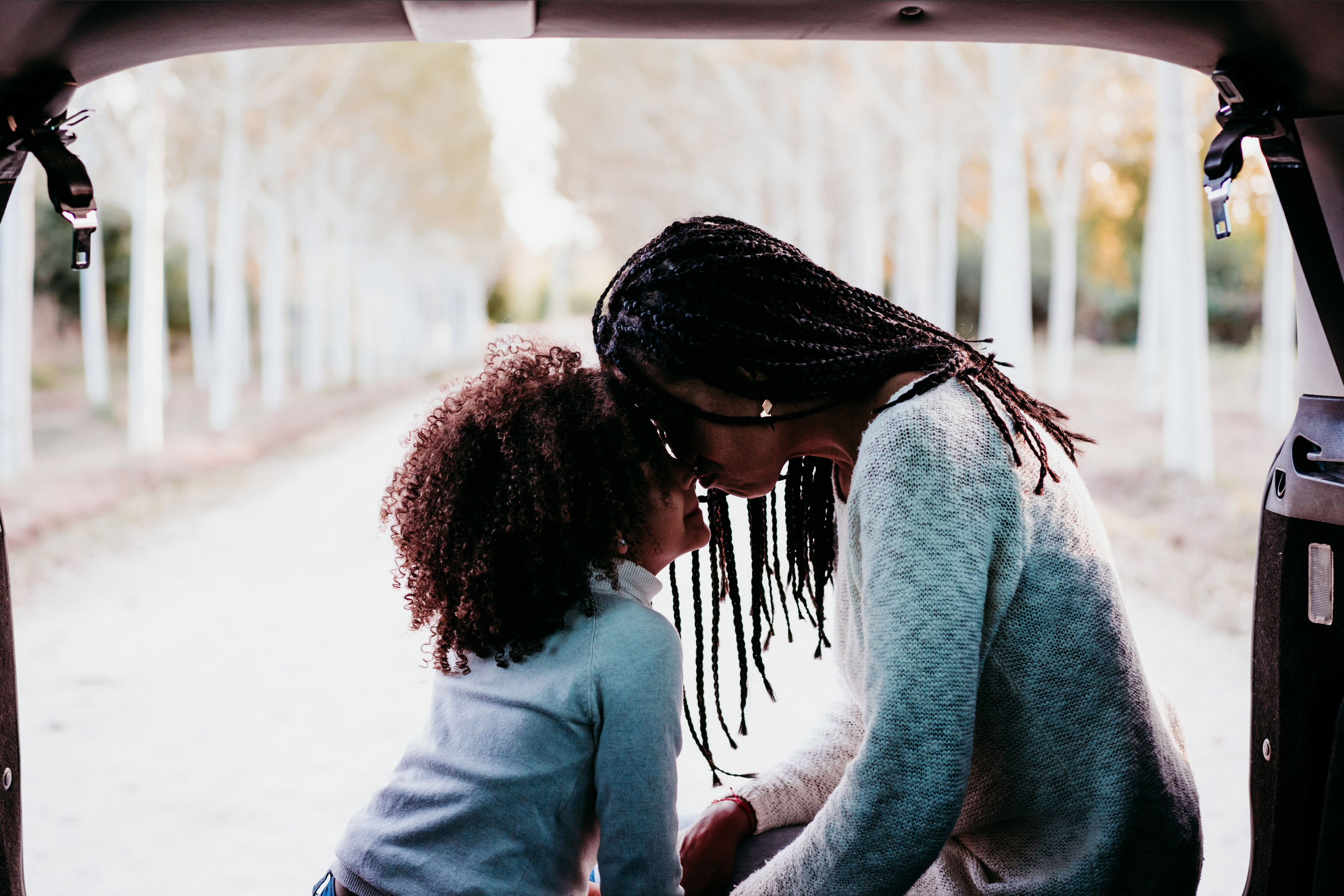 African America mother and child heads touching