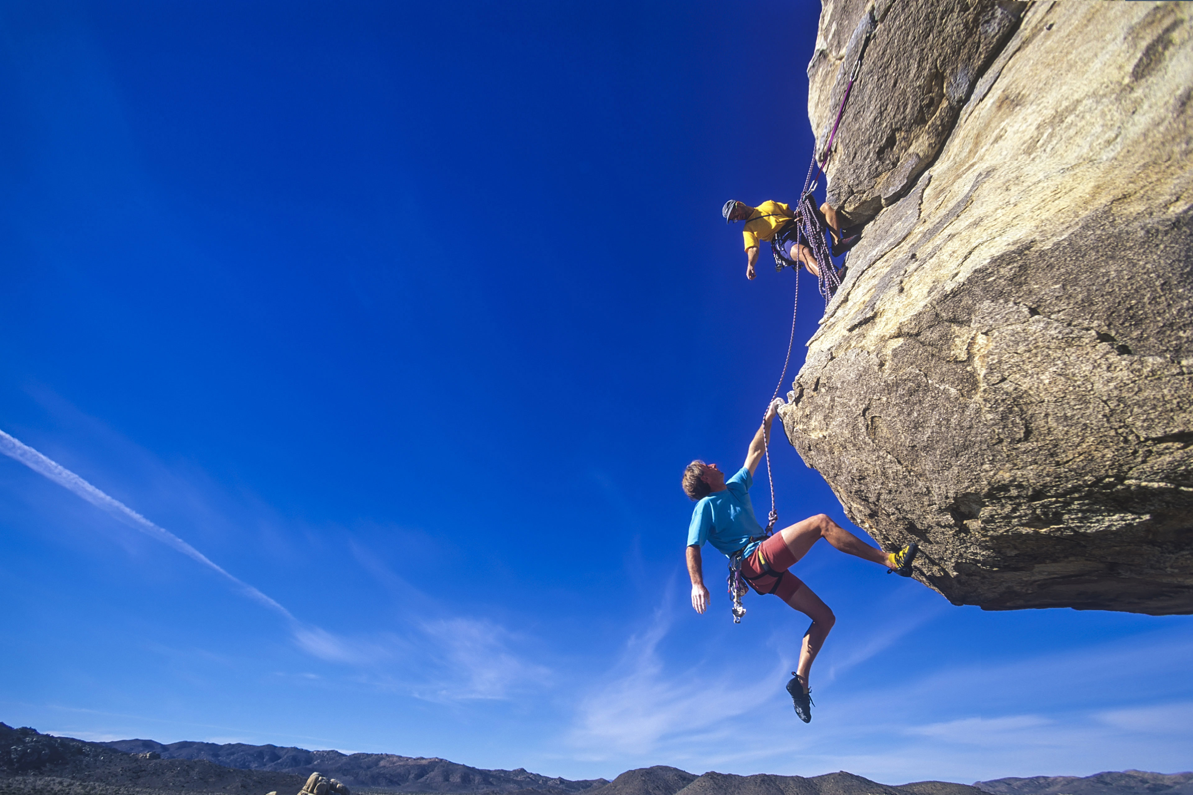 Climbers hanging over the void