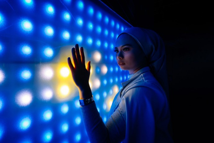 Portrait of woman holding illuminated lights