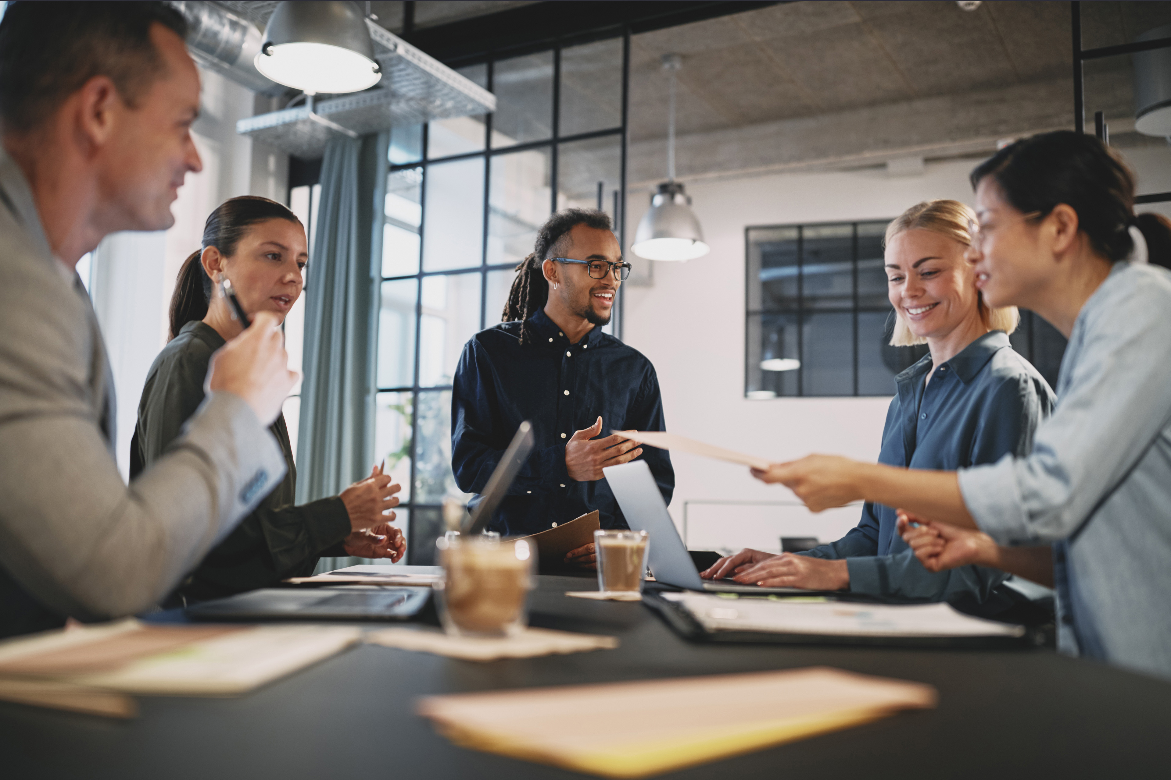 Young businessman talking with staff in office meeting