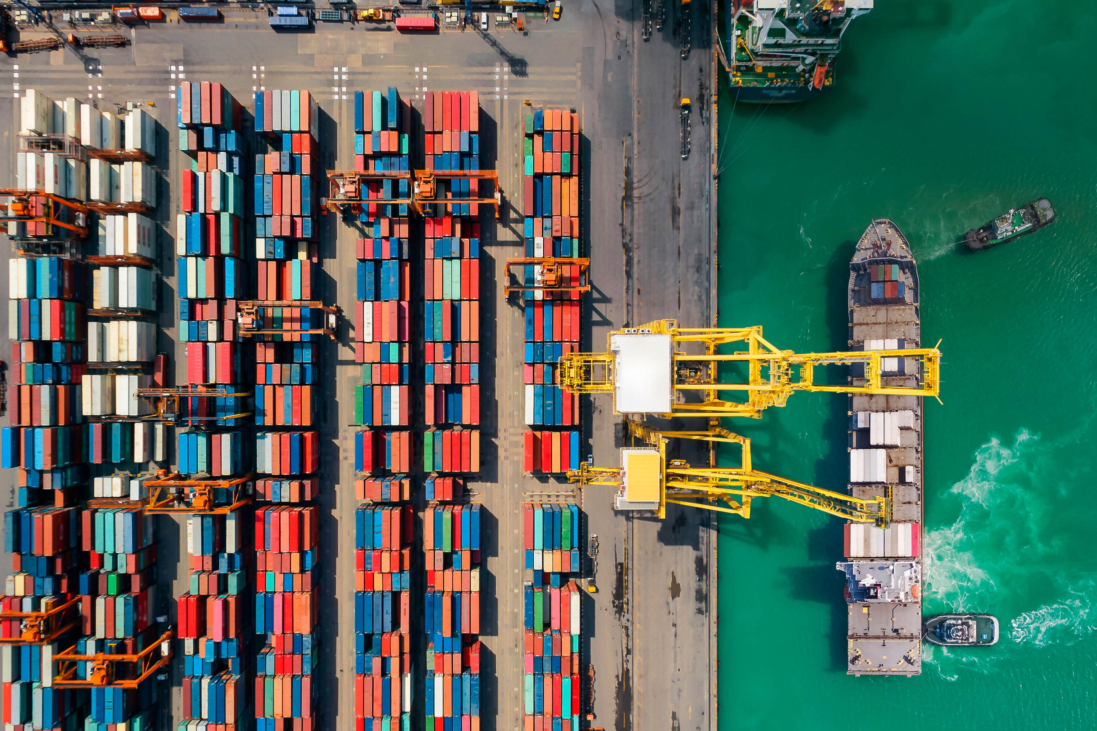 Container ship aerial view with green water