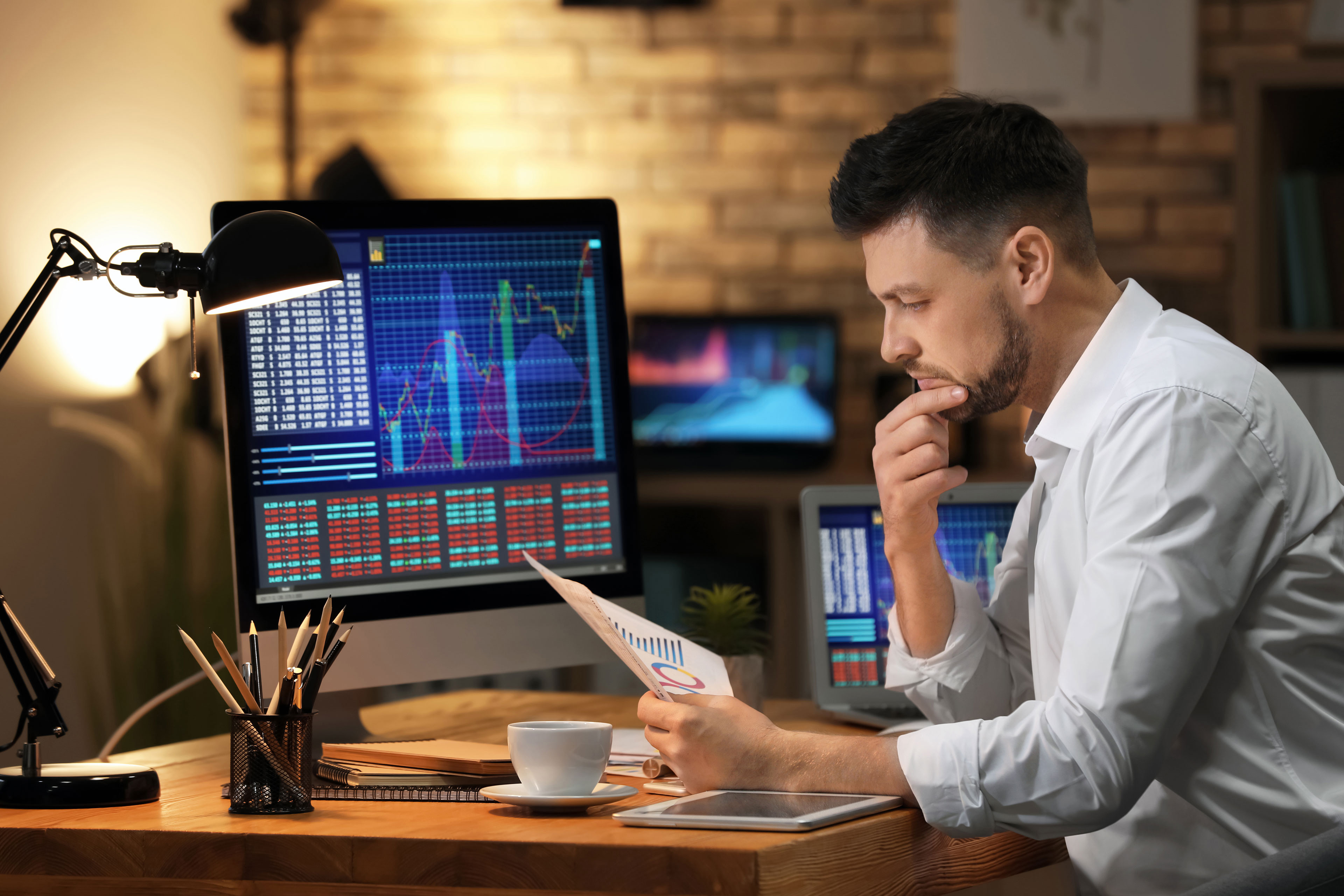 Young stock exchange trader working in office