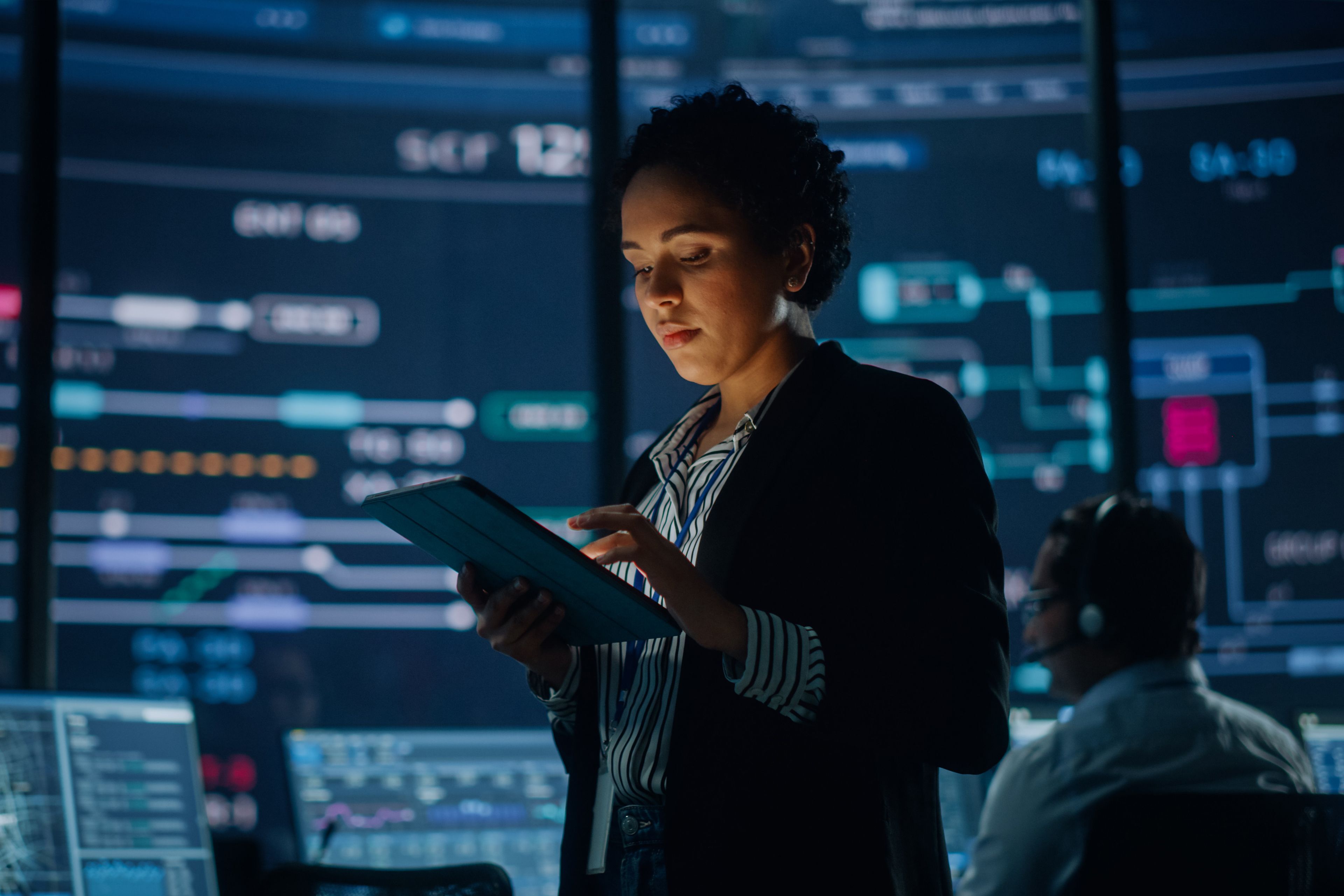 EY a woman uses a tablet showing technology in future workplace