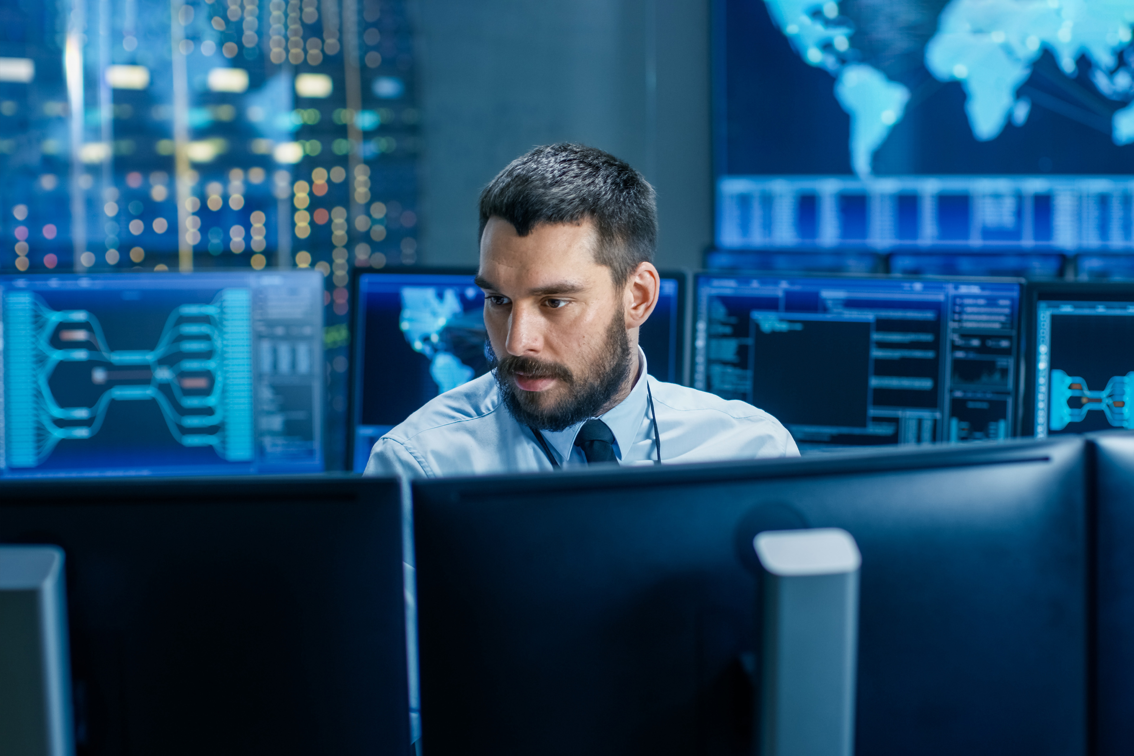 operator working surrounded by displays showing relevant data