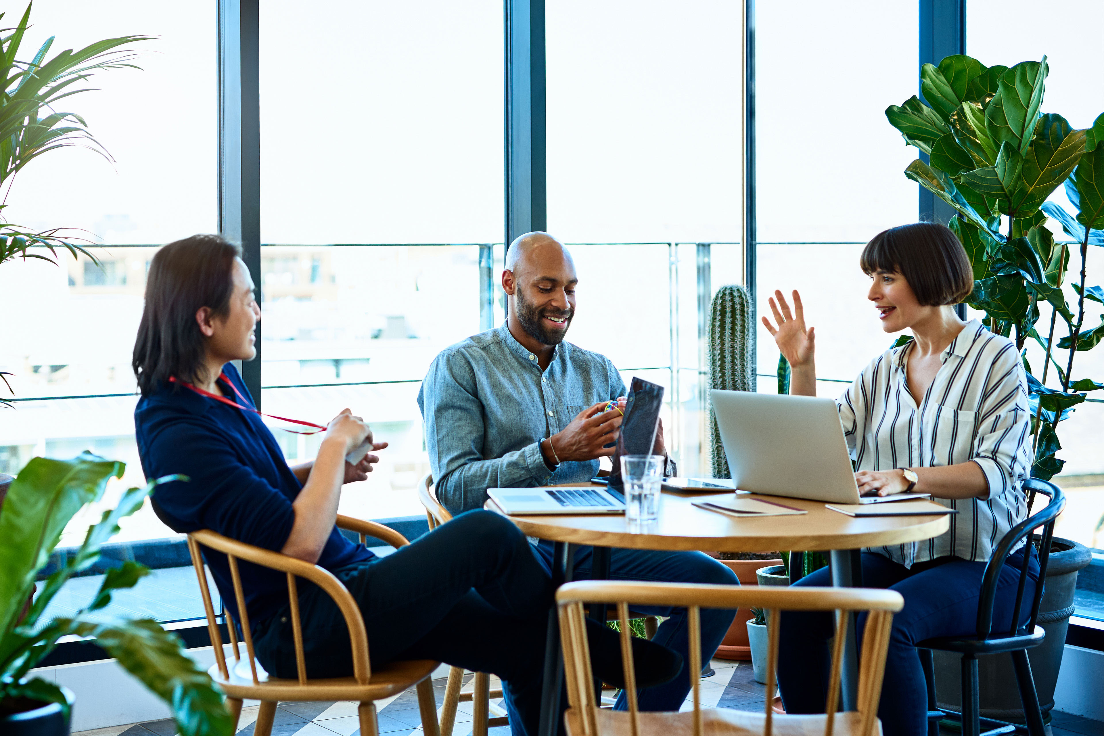 Three relaxed business colleagues meeting in cafe