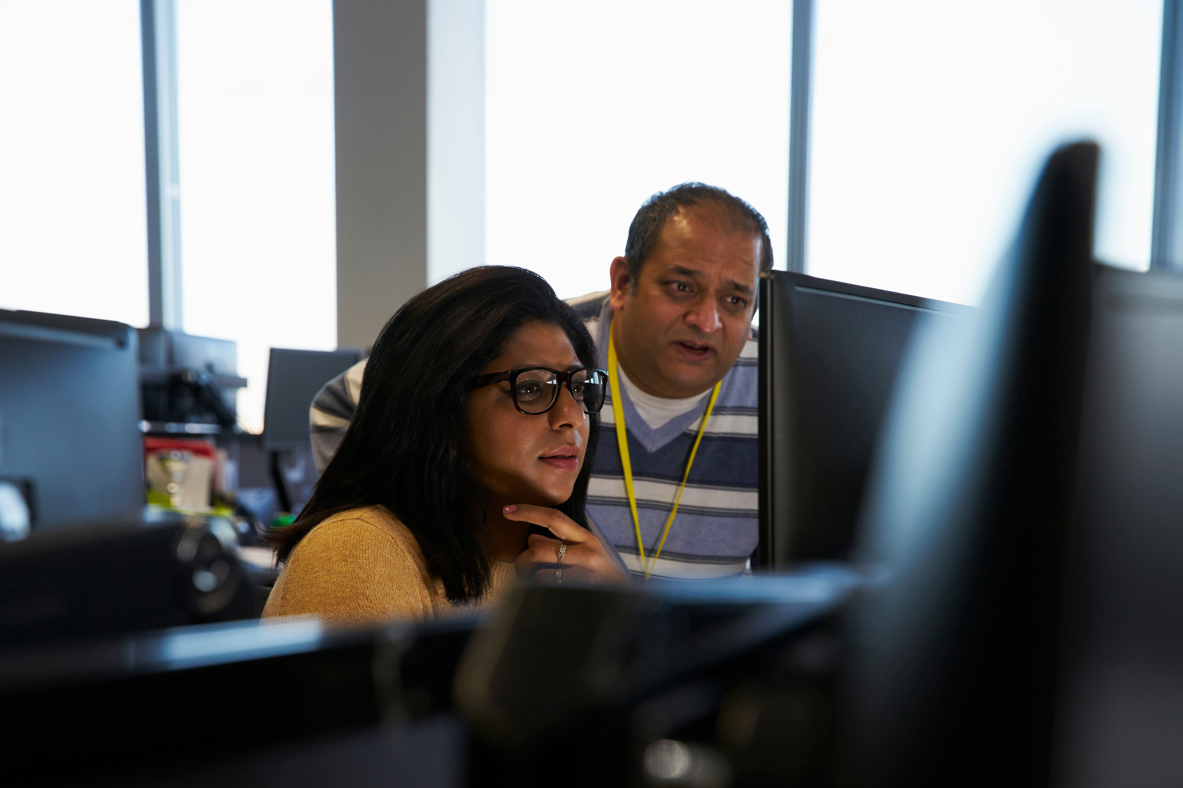 ey business people working at laptop in office  