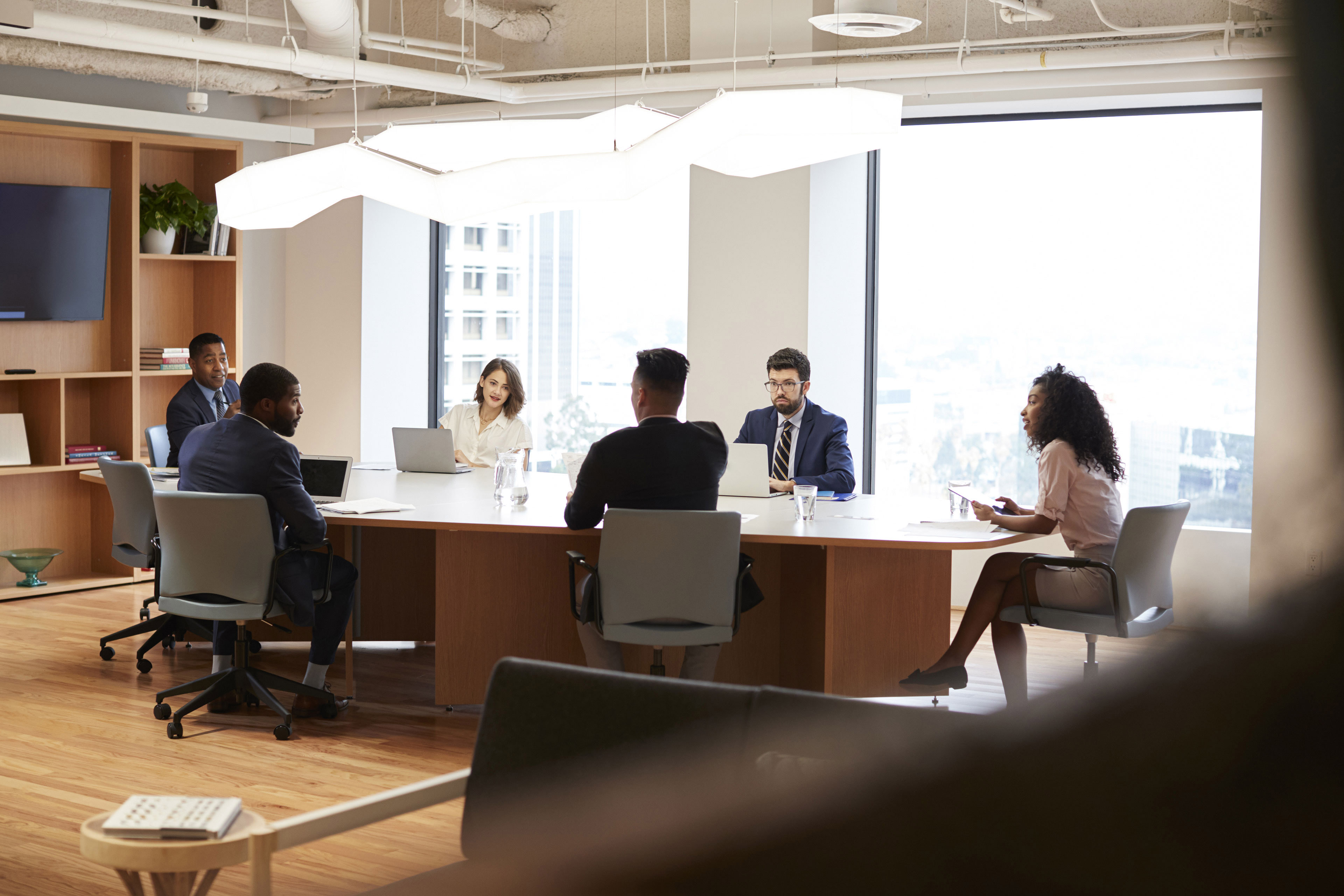 Group of business professionals meeting around table