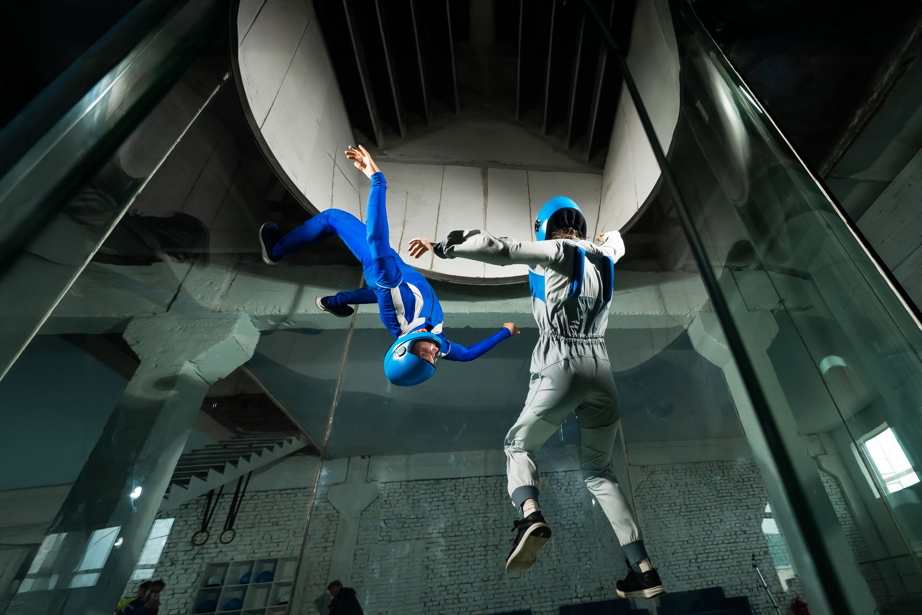 Man and a woman enjoy flying together in a wind tunnel