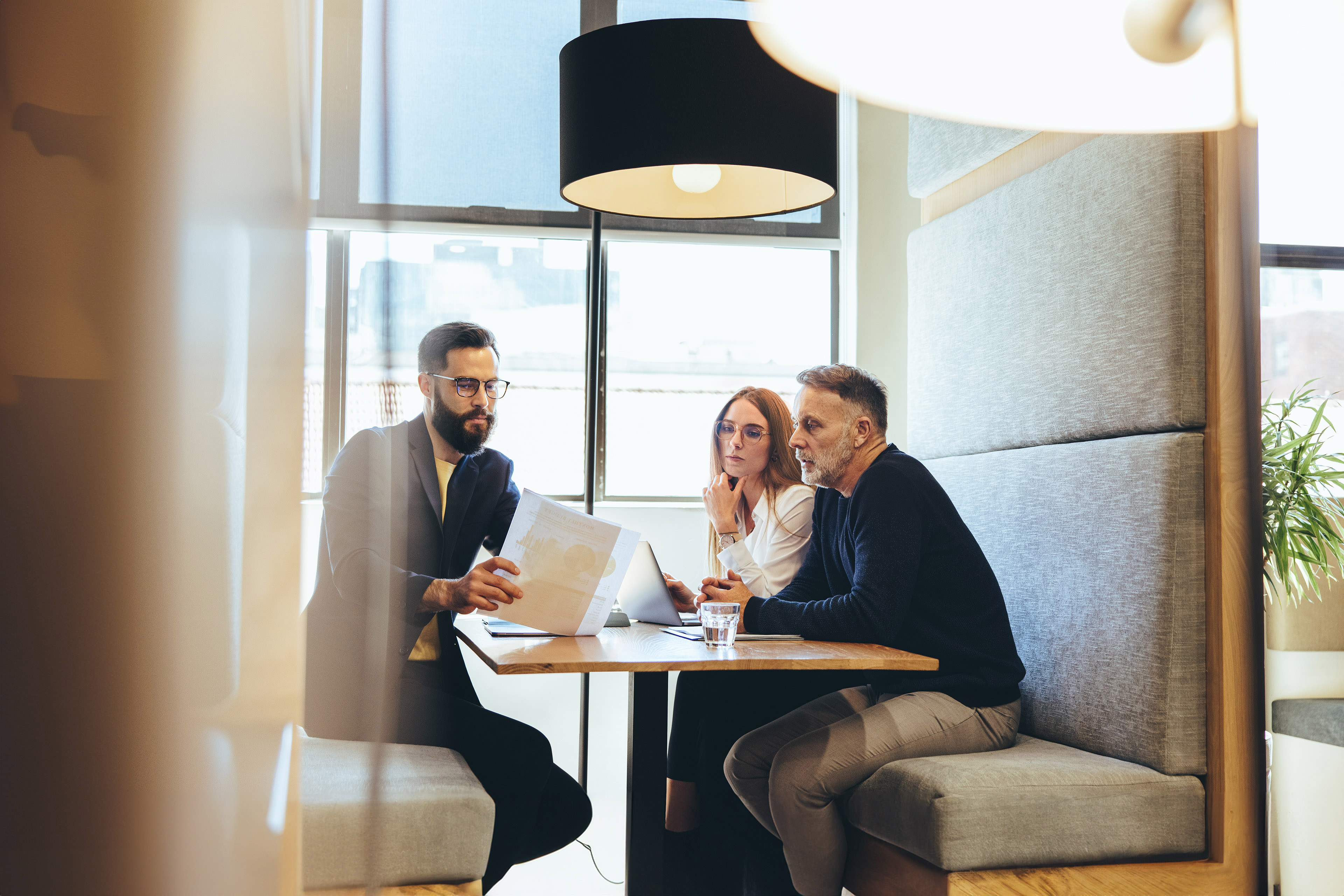 Three business colleagues looking at a document while working together