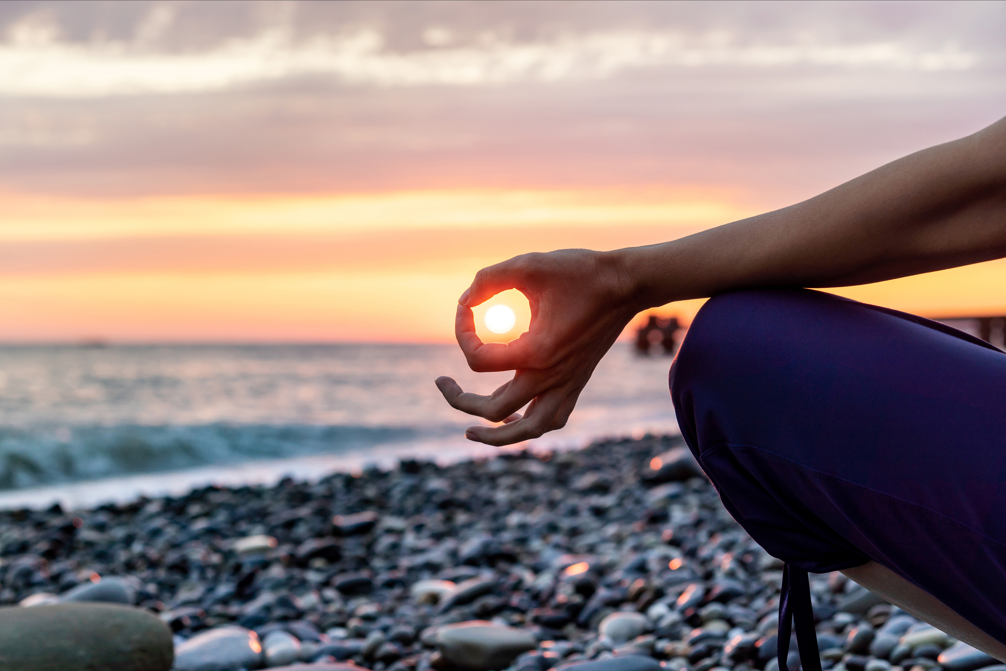 Female practicing yoga on beach