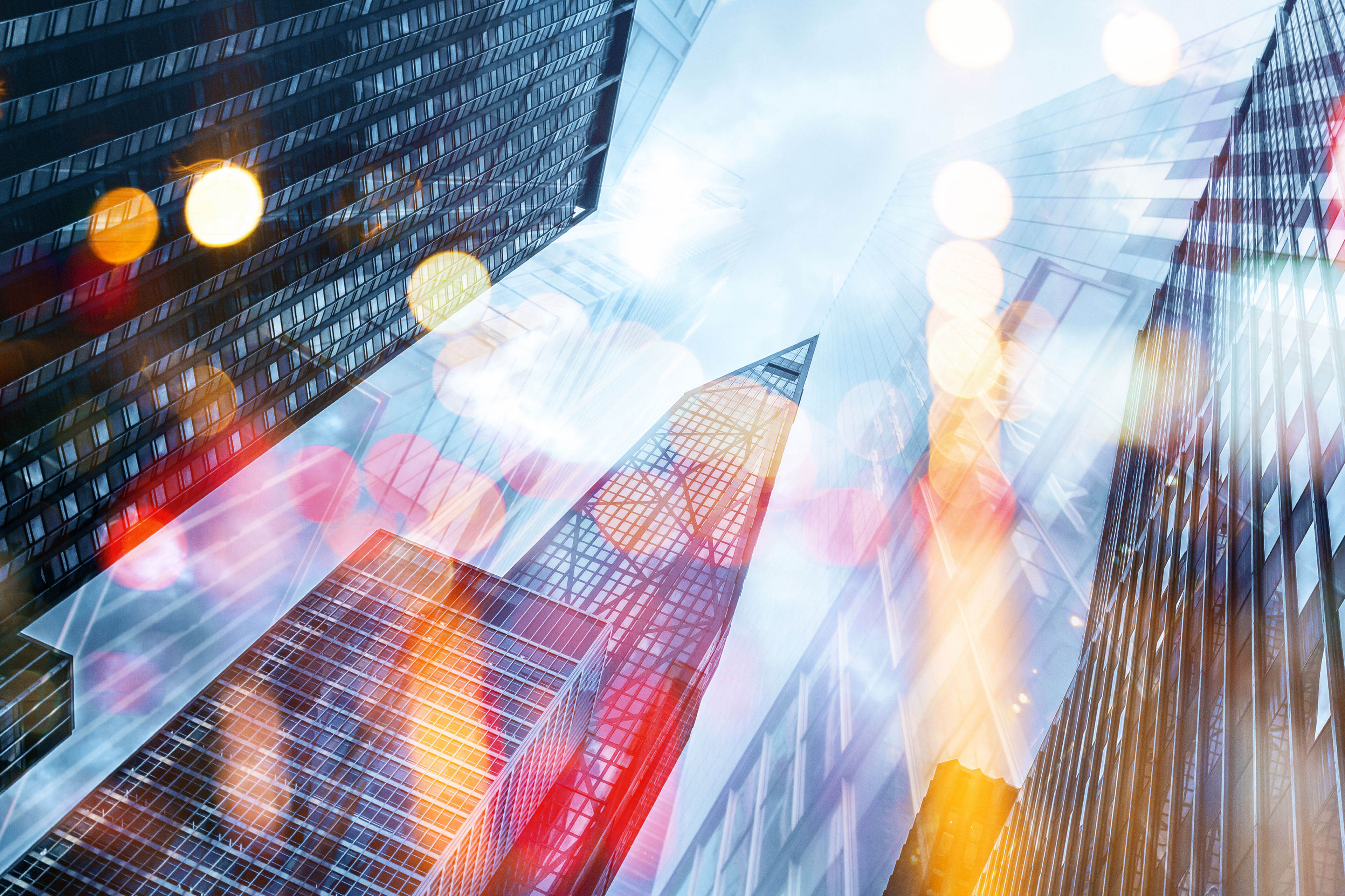 Low angle view of skyscrapers with bokeh color