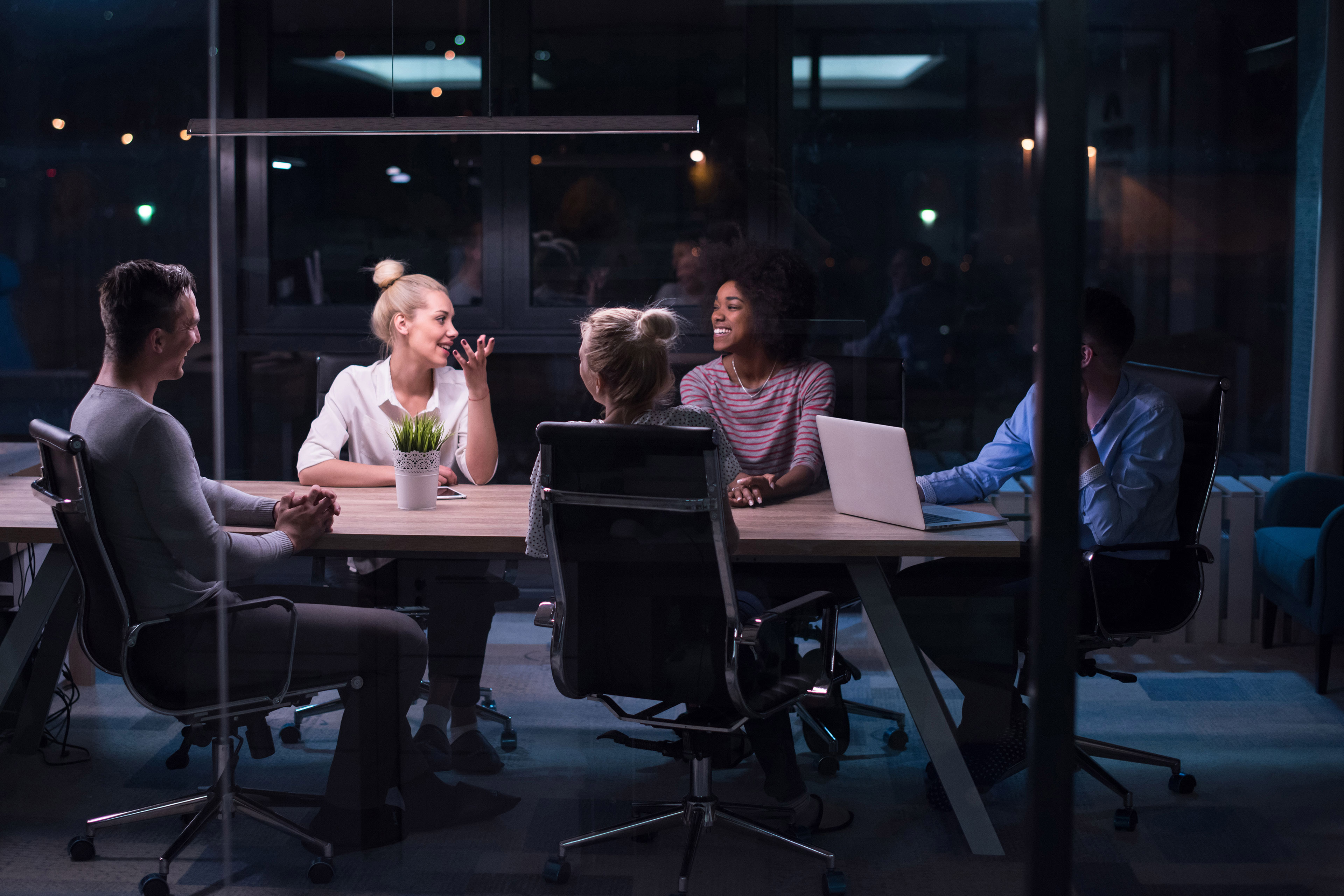 Multiethnic business team meeting in night office