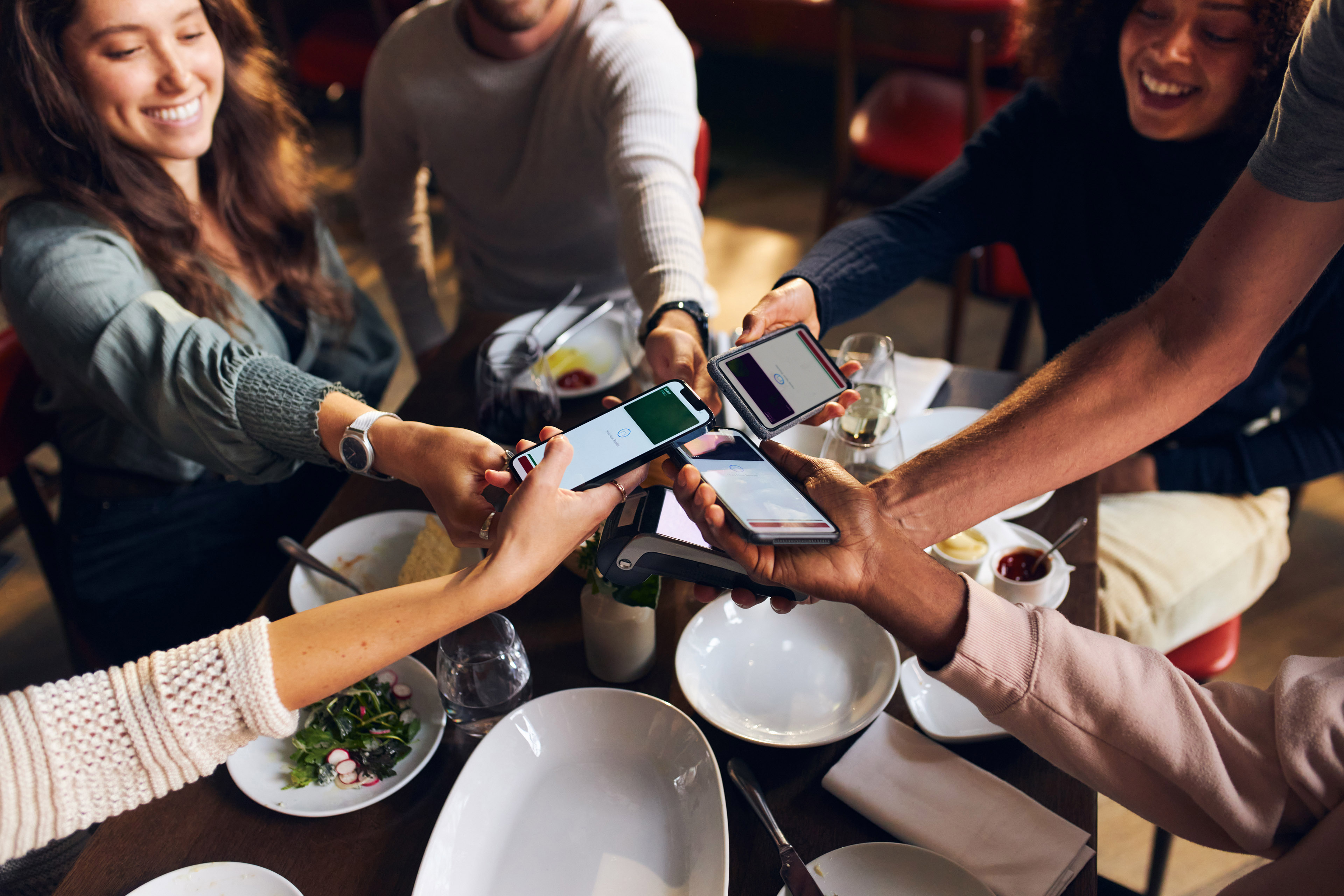 Friends splitting the bill in restaurant