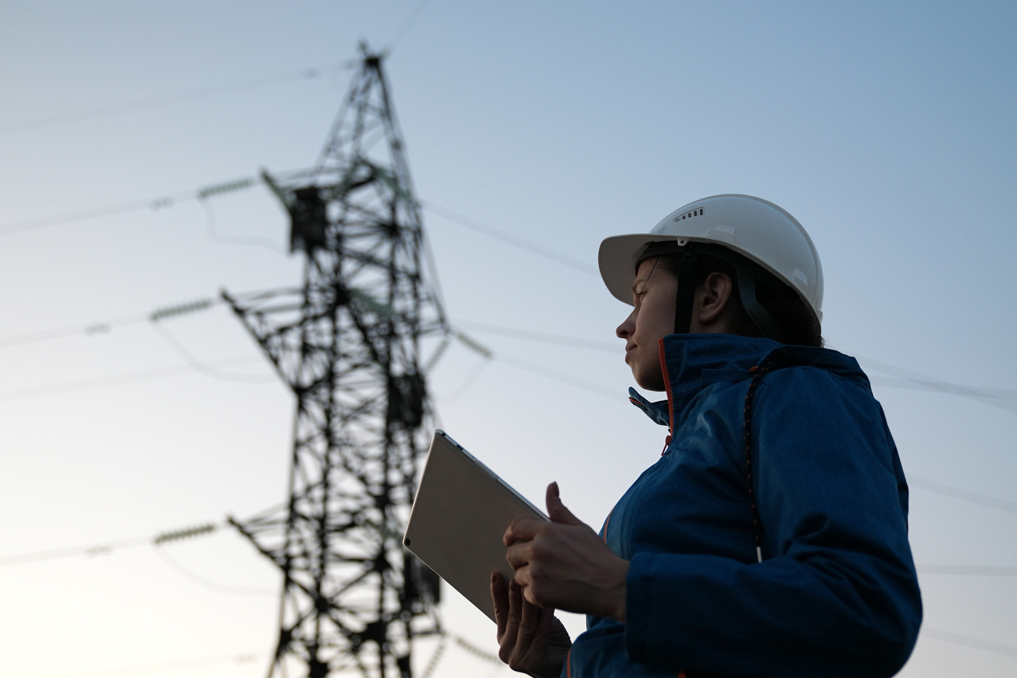 Woman power engineer in white helmet