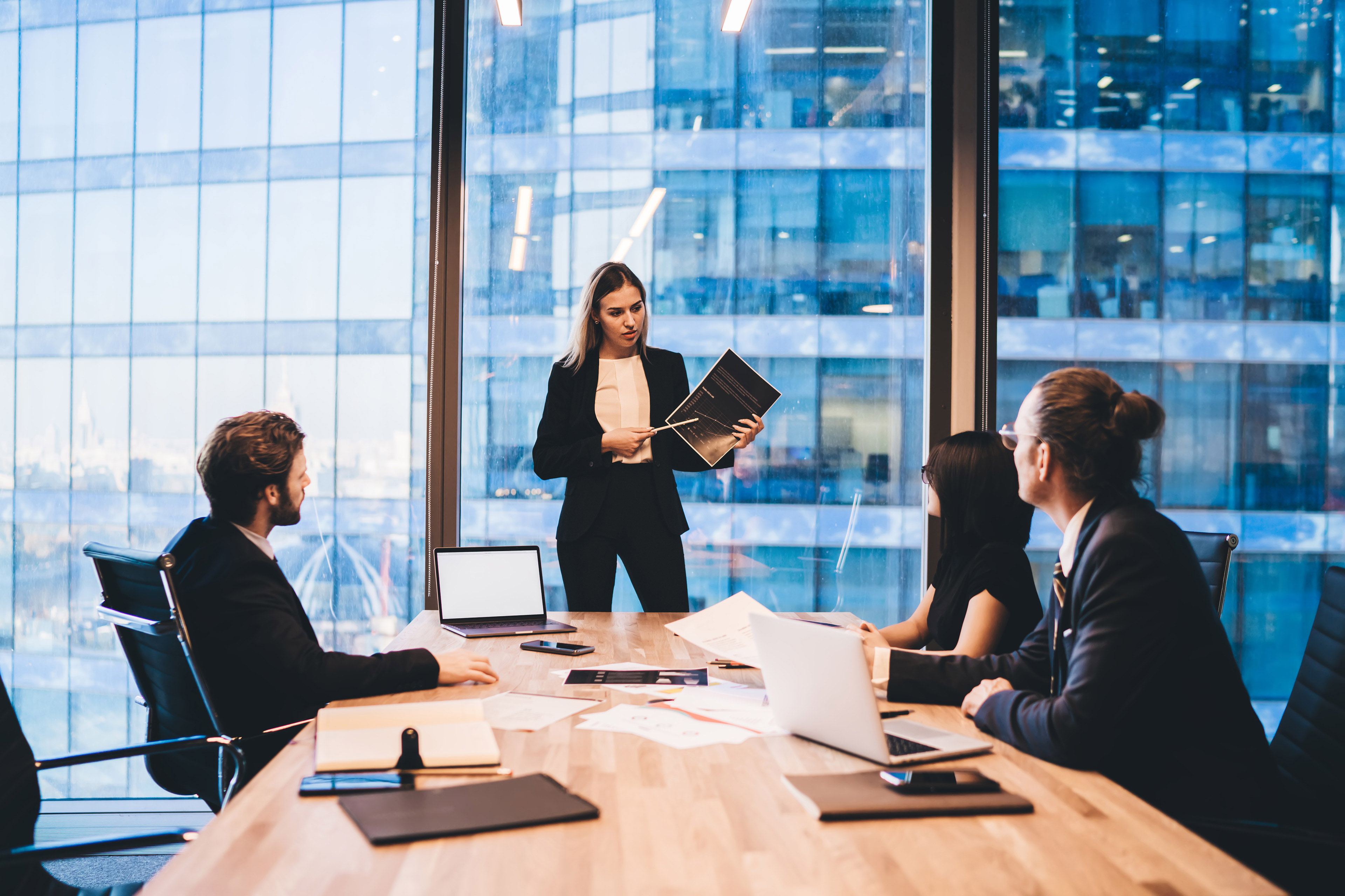 Confident woman explaining project to colleagues