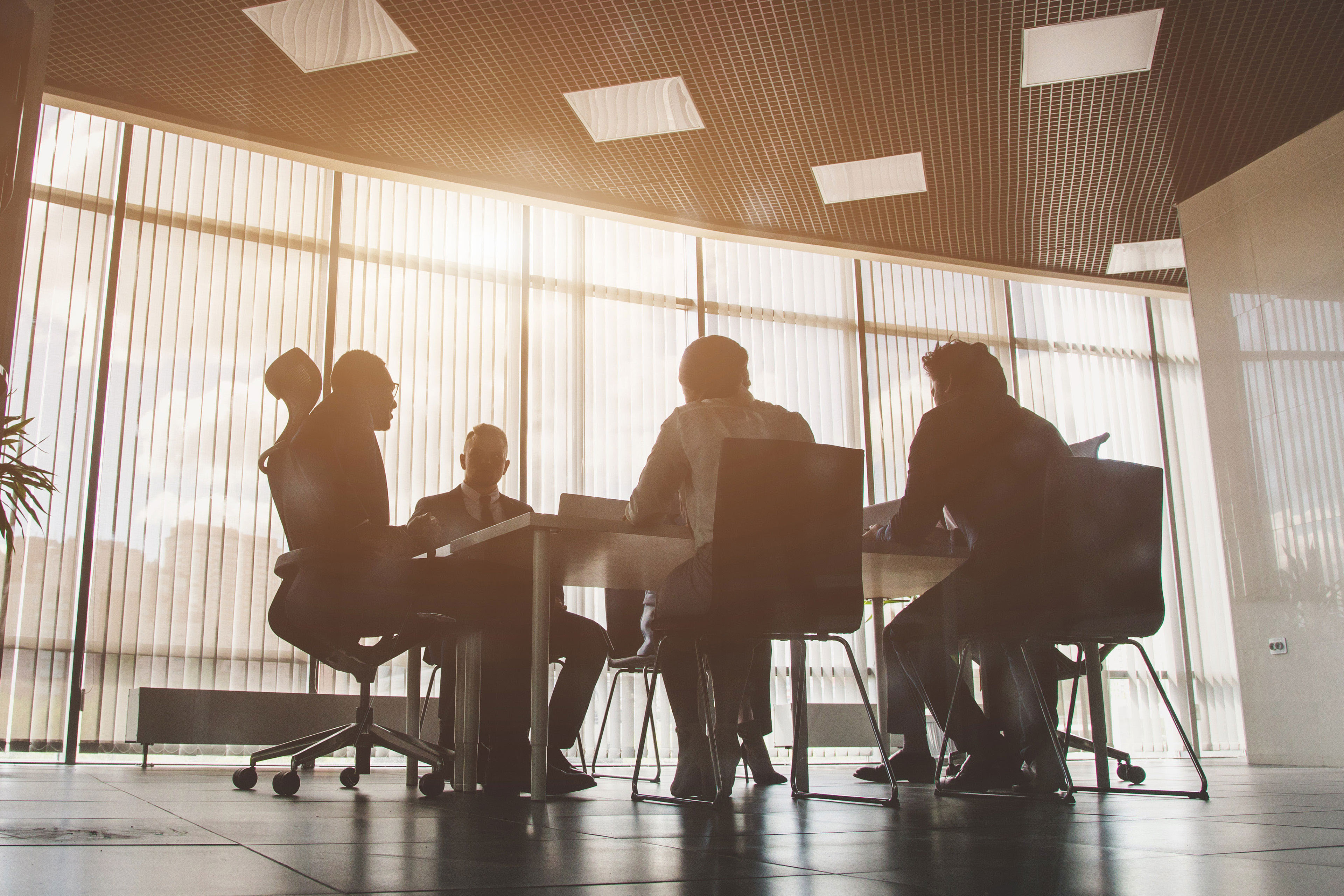 Silhouettes of people sitting at the table