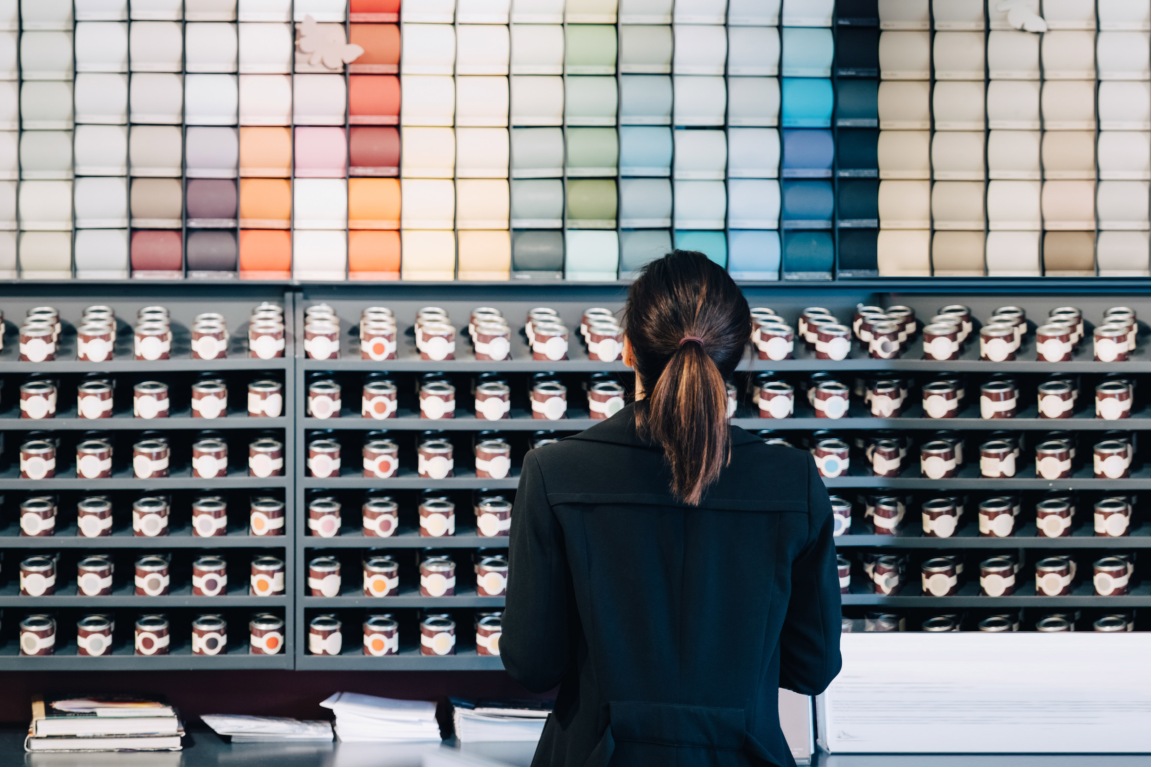 Woman choosing wallpapers and paints