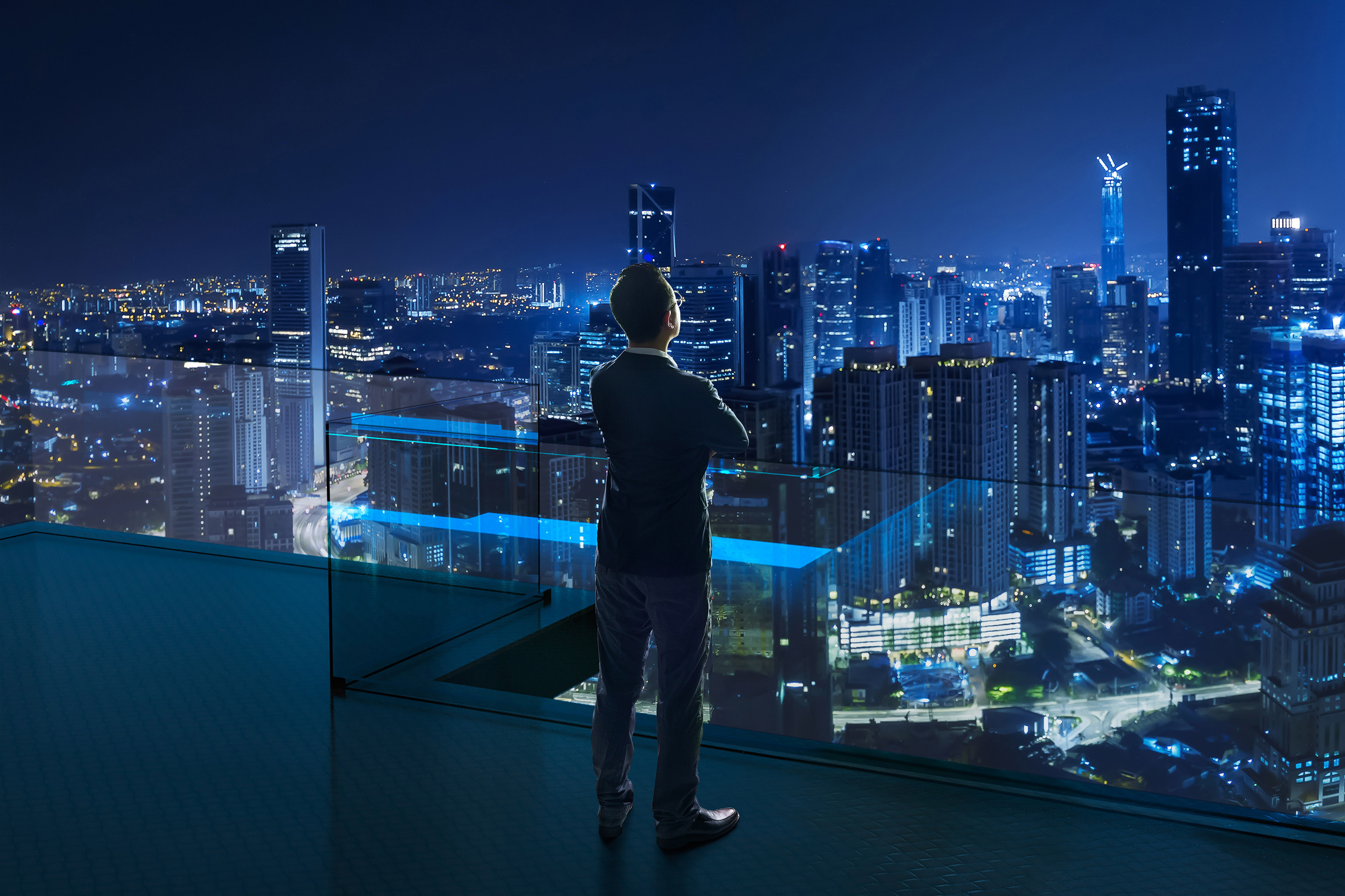 Businessman standing on open roof top balcony