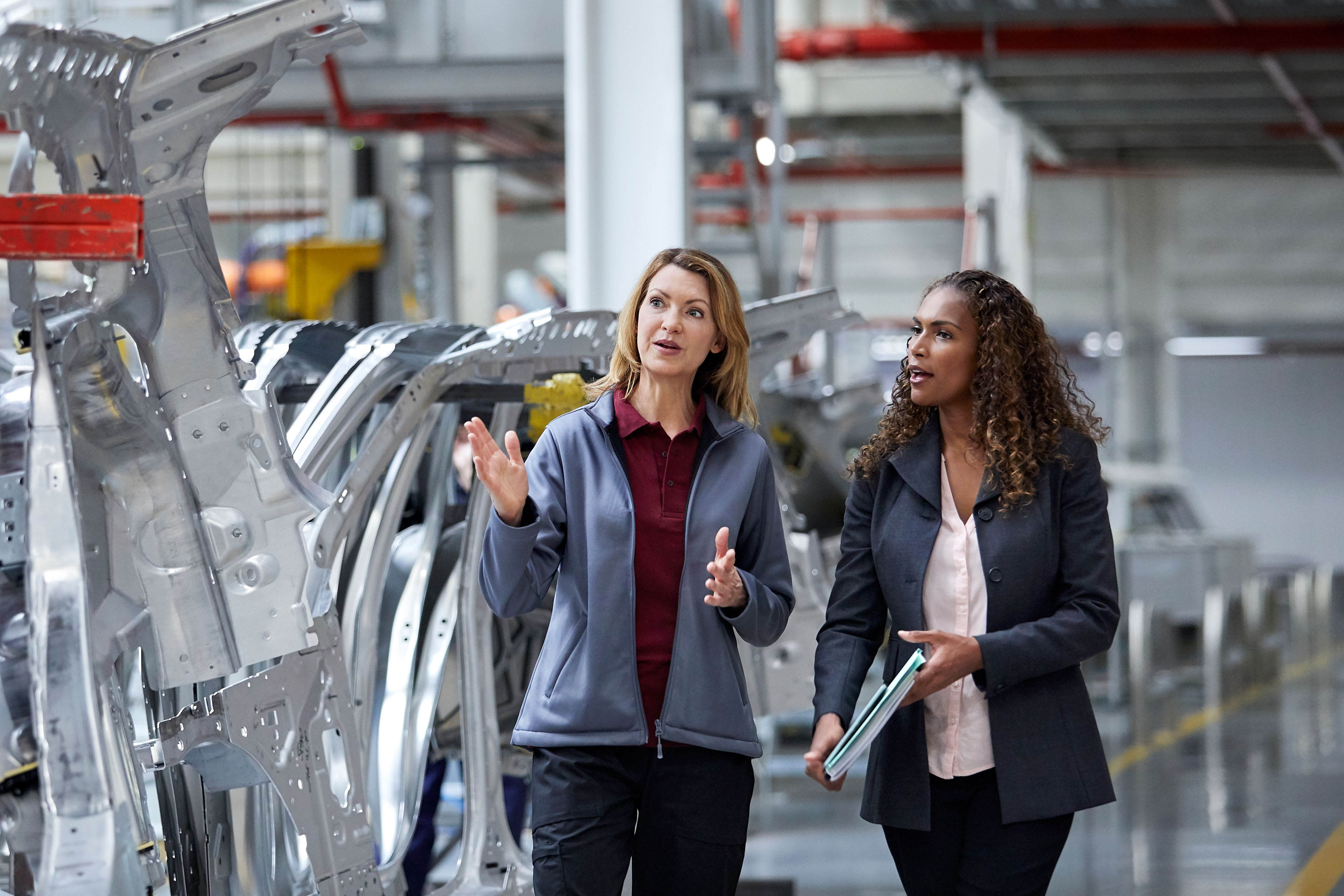 EY - Engineers-discussing-over-car-chassis-in-factory