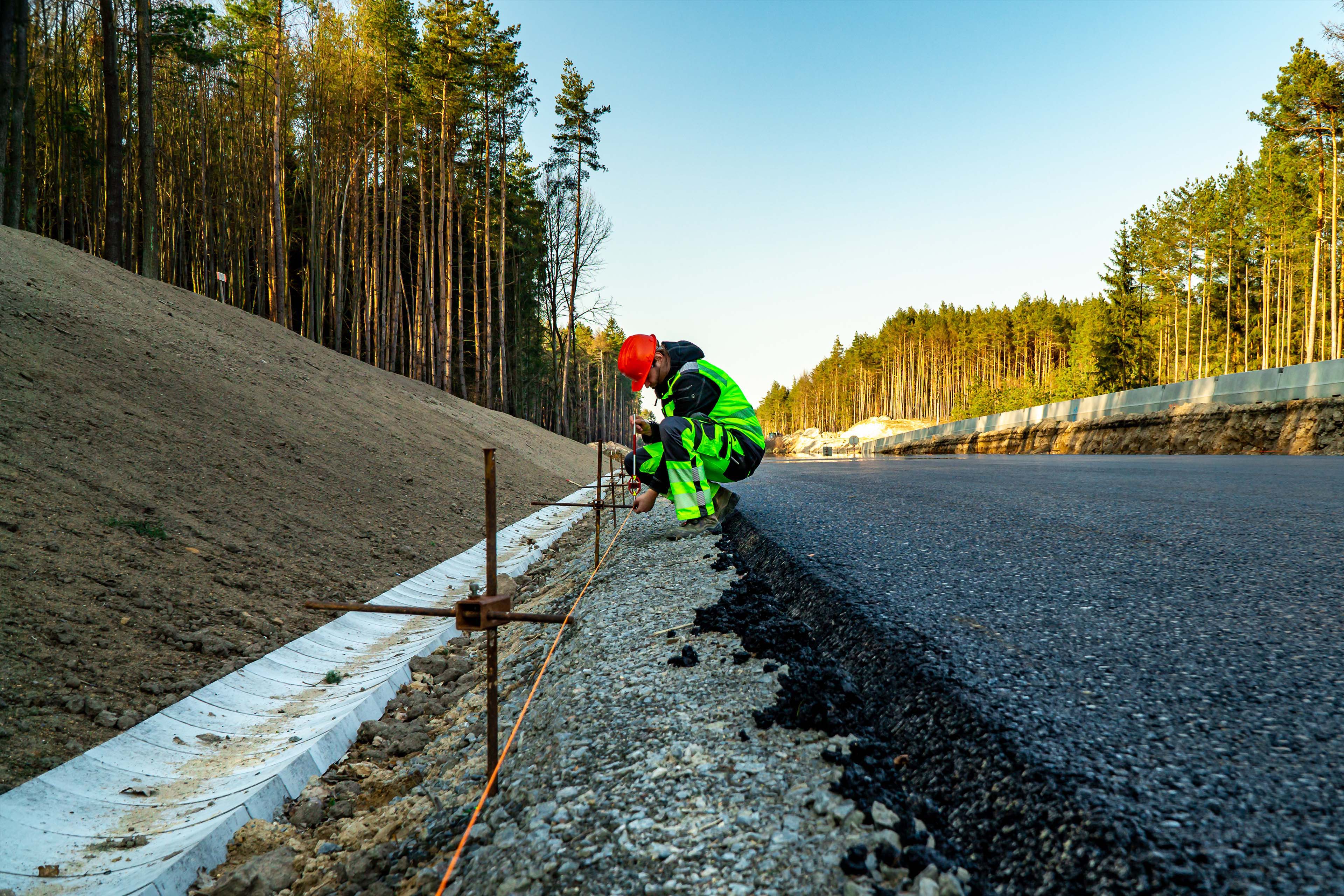 Surveyor with equipment on the construction site of the road