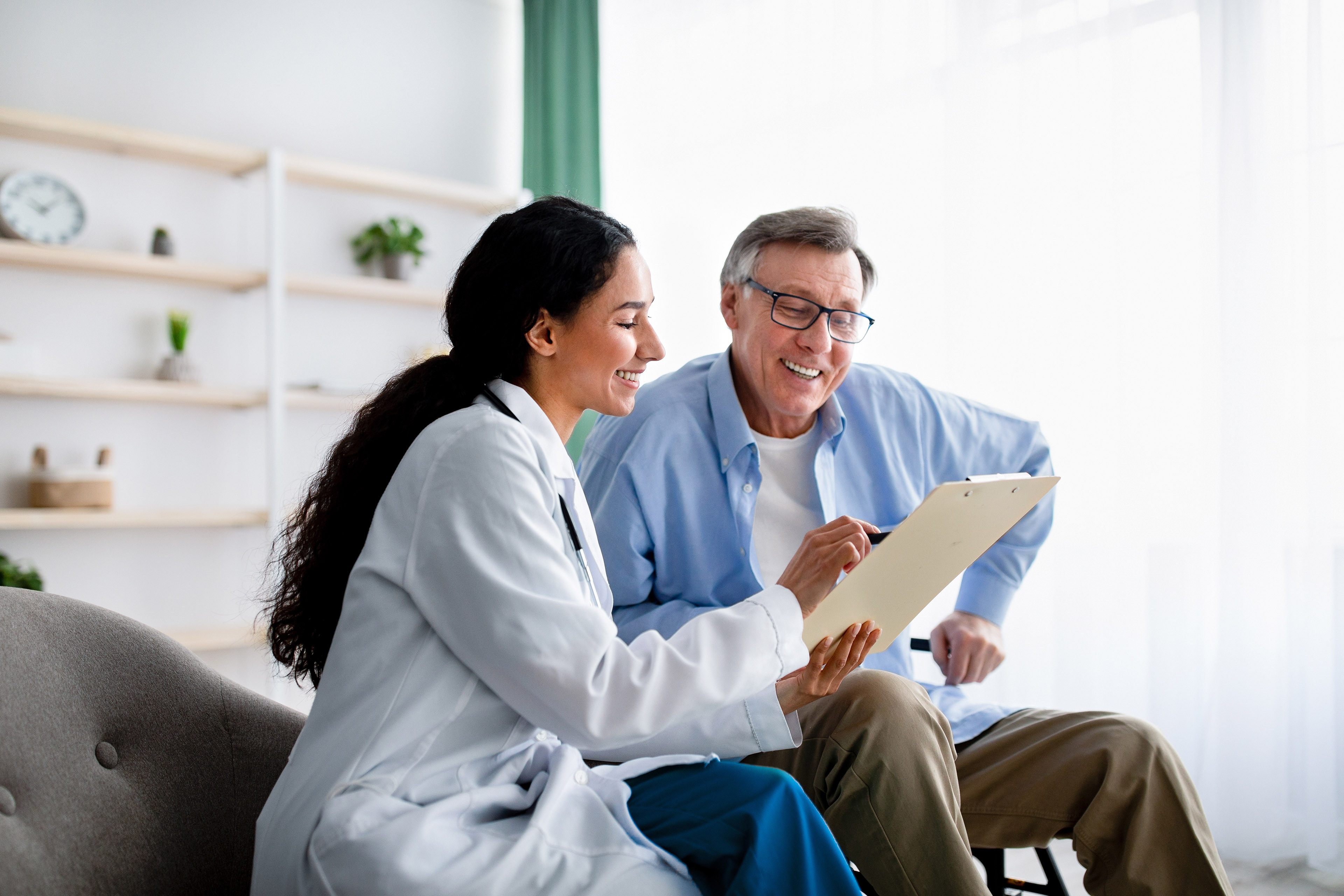 Young doctor asking senior impaired male patient