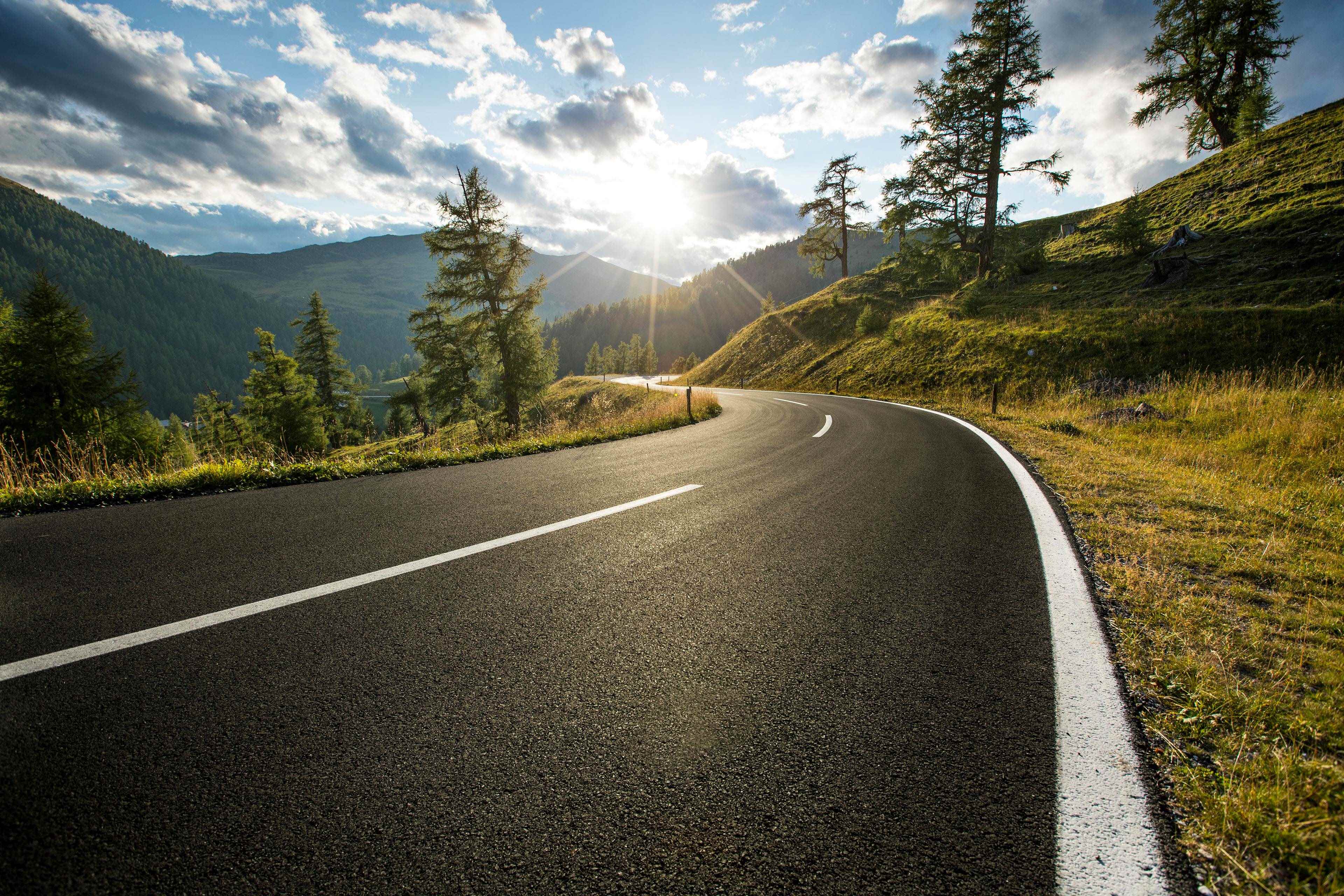 sunrise in the distance on a road to the mountains a positive journey