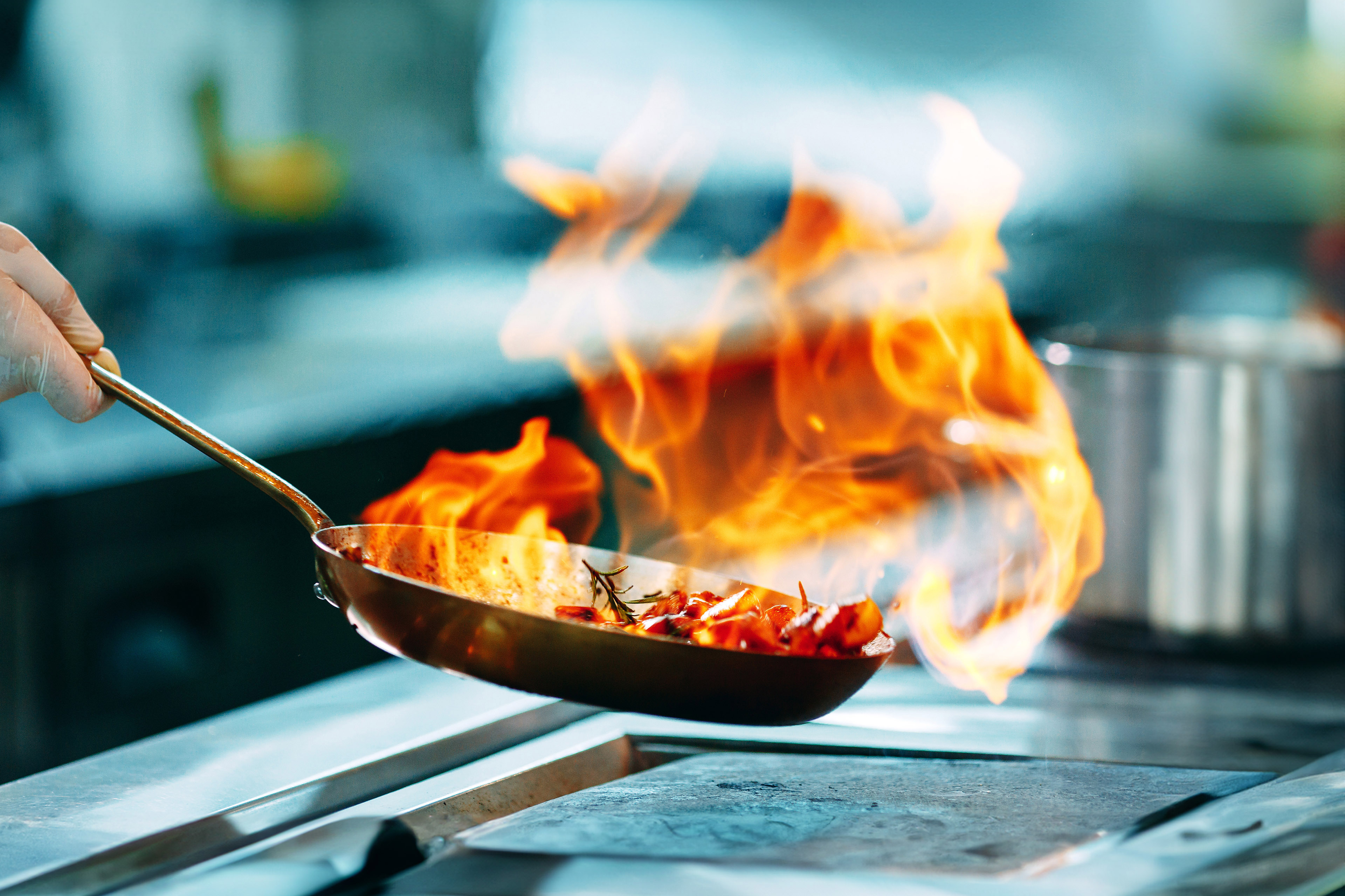 Cooks prepare meals on the stove in the kitchen