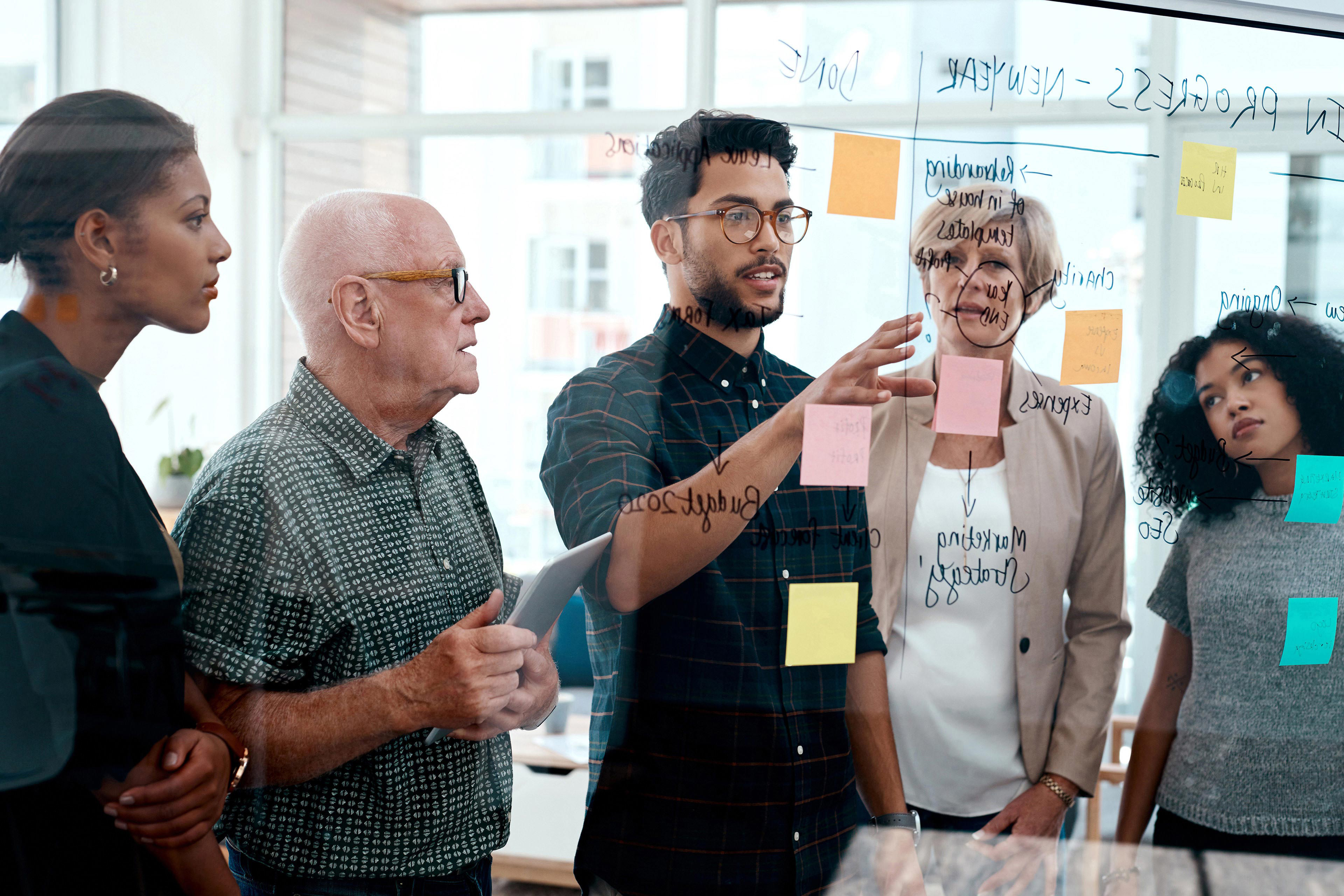 Team of business people brainstorming with notes