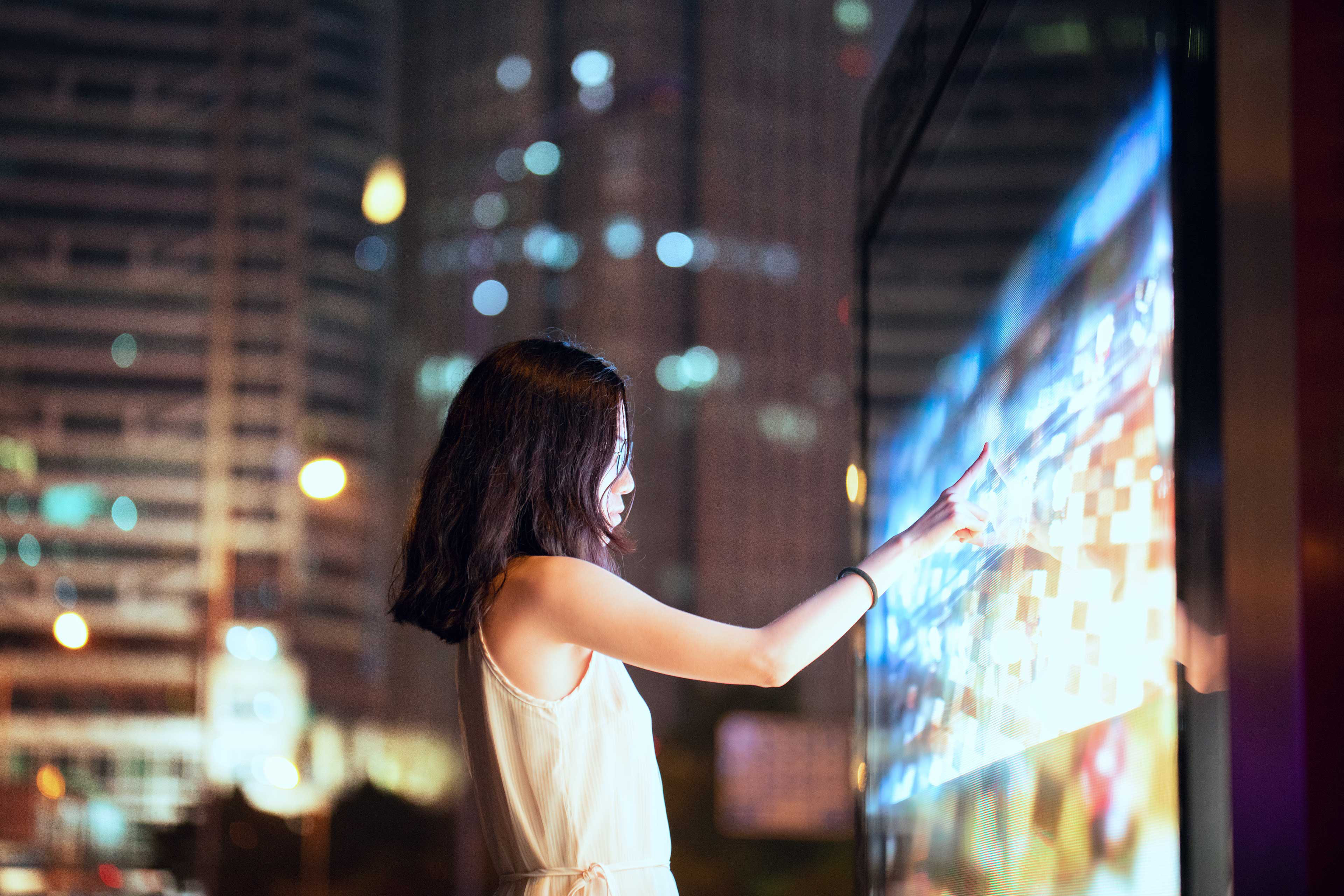 EY - Young-female-using-touch-screen-on-the-street