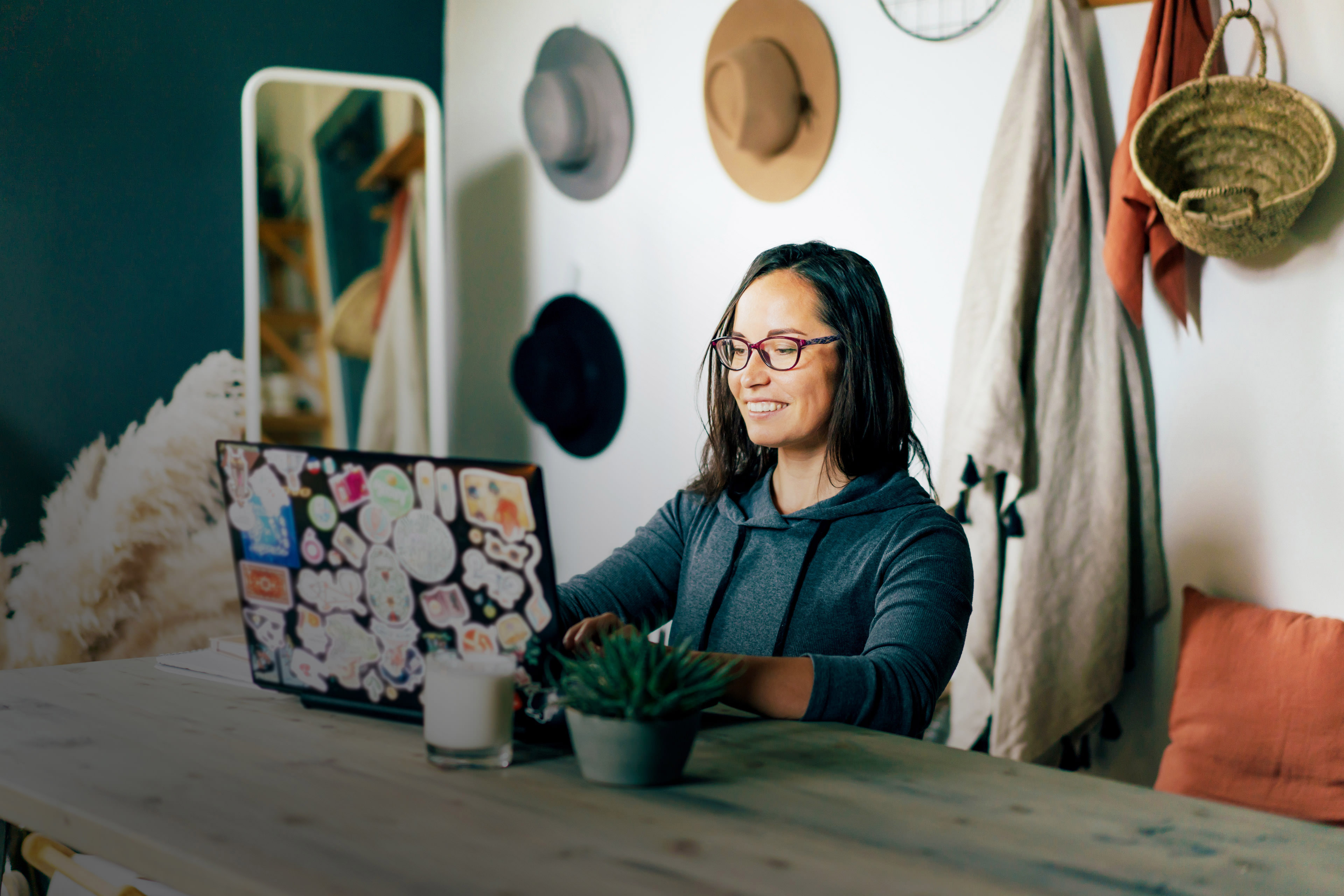 Happy woman works on a laptop