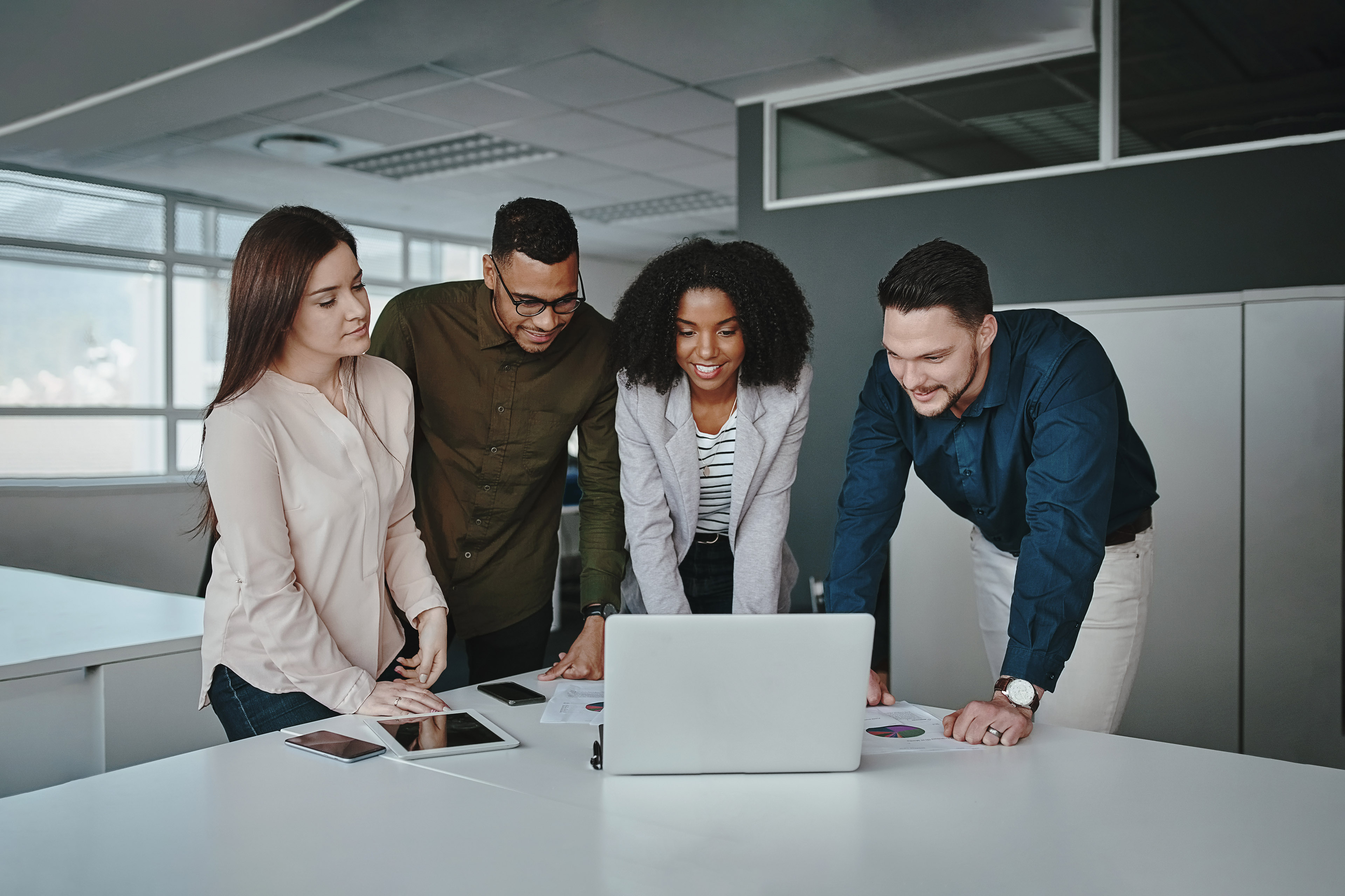 Smiling multiethnic coworkers working together