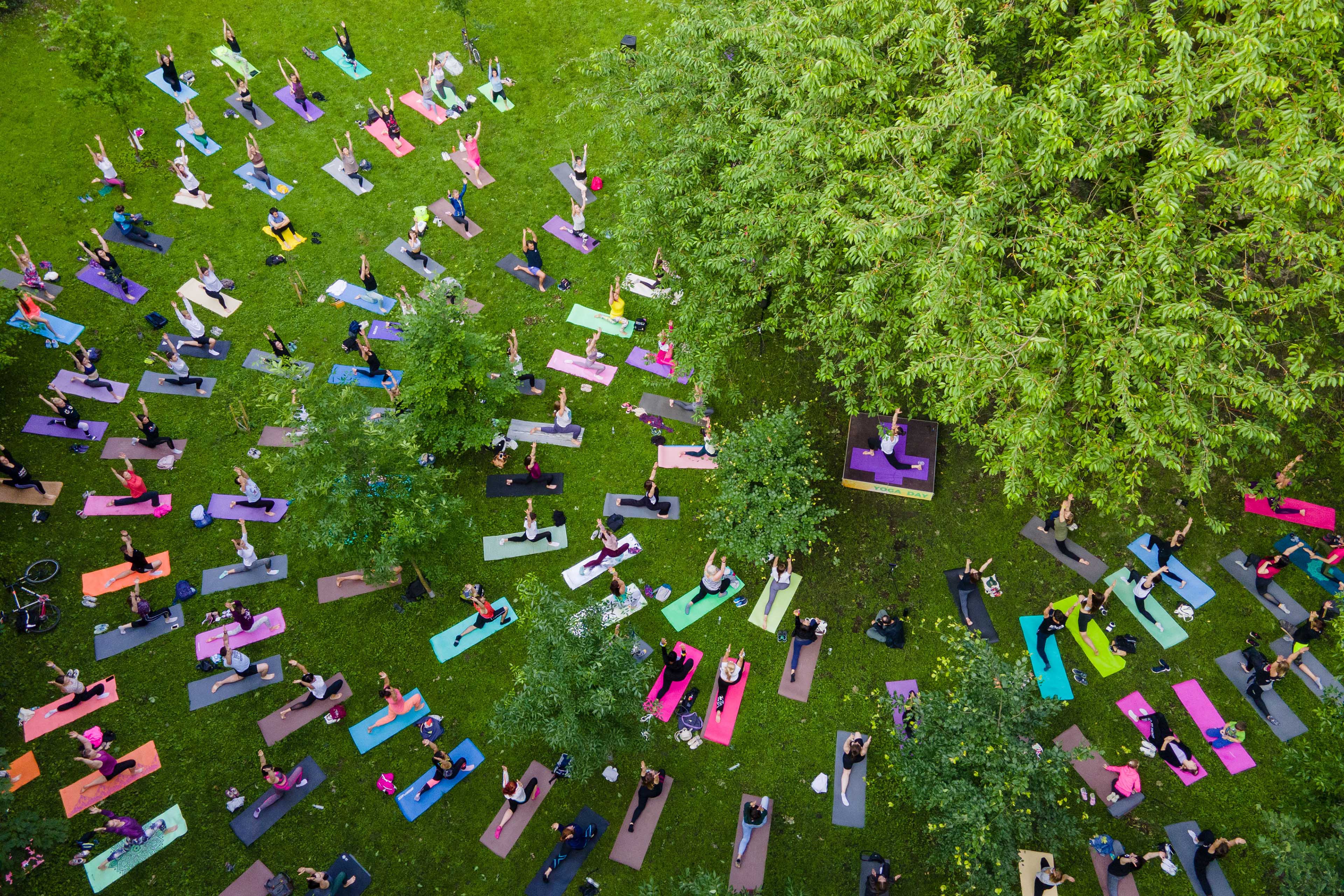 Overhead view of people doing yoga at city park 