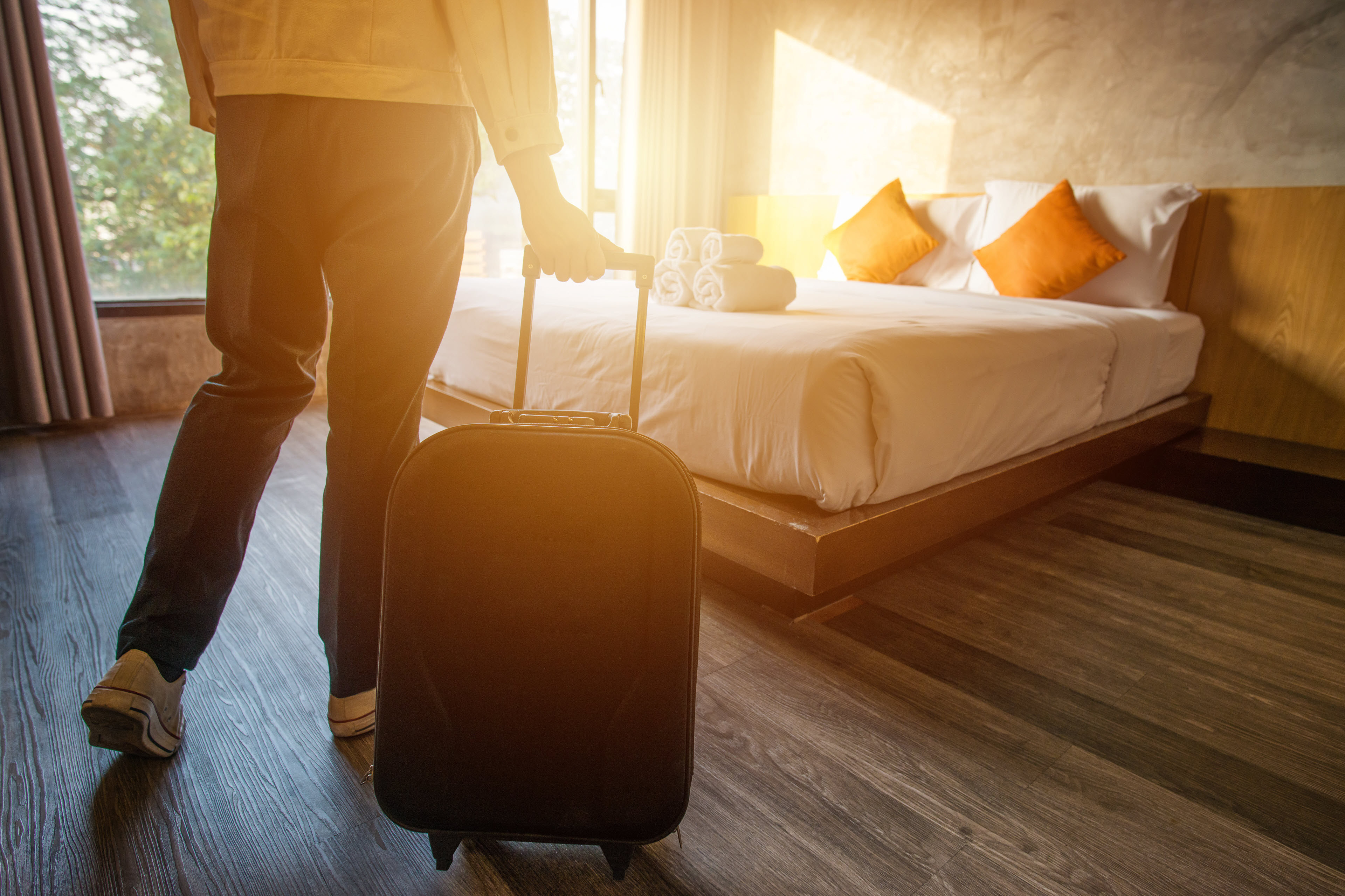 Person arriving at hotel room during morning