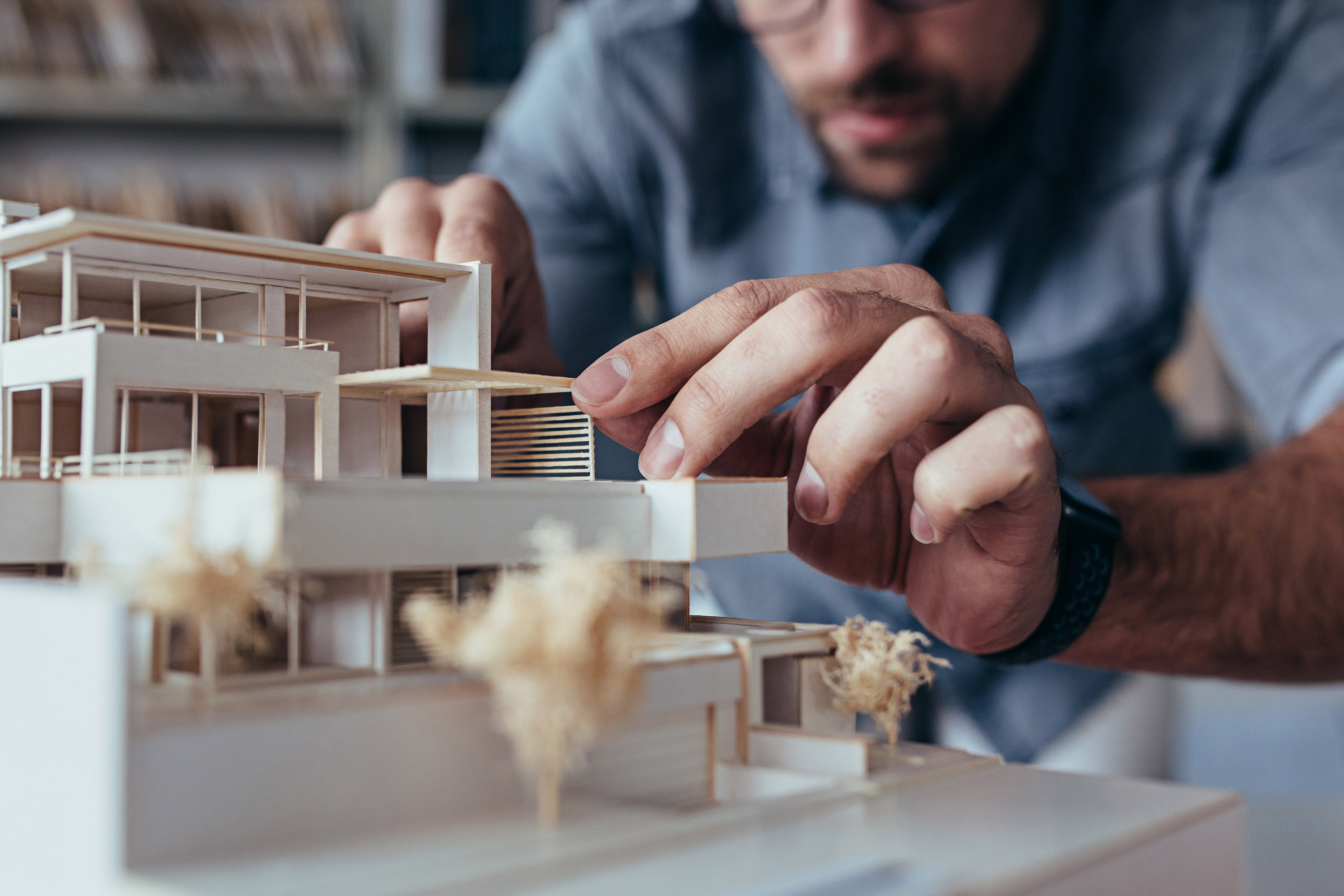 Architect hands making model house