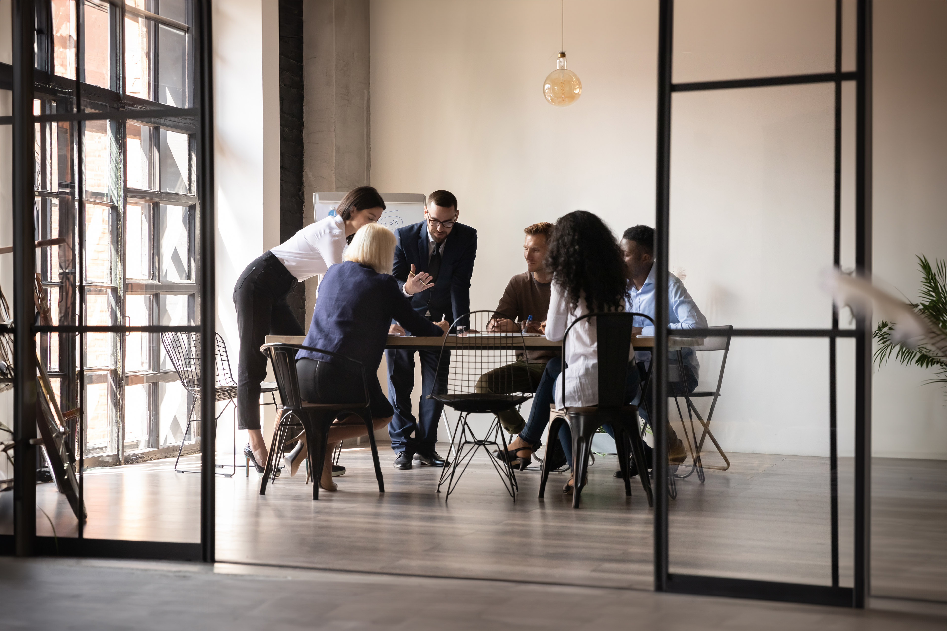 EY diverse employees team engaged in teamwork in modern boardroom