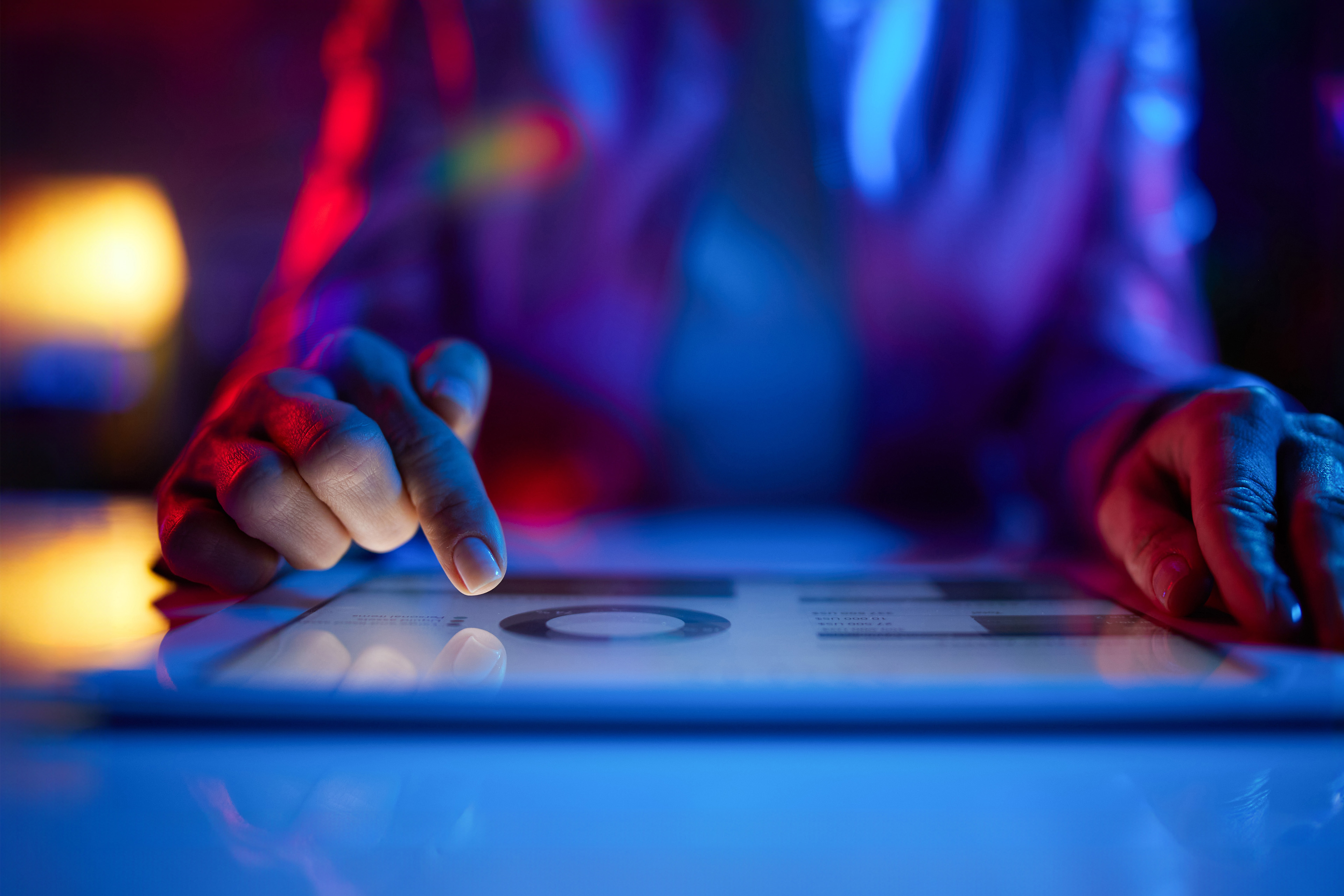 Woman pointing a data seen in a tablet