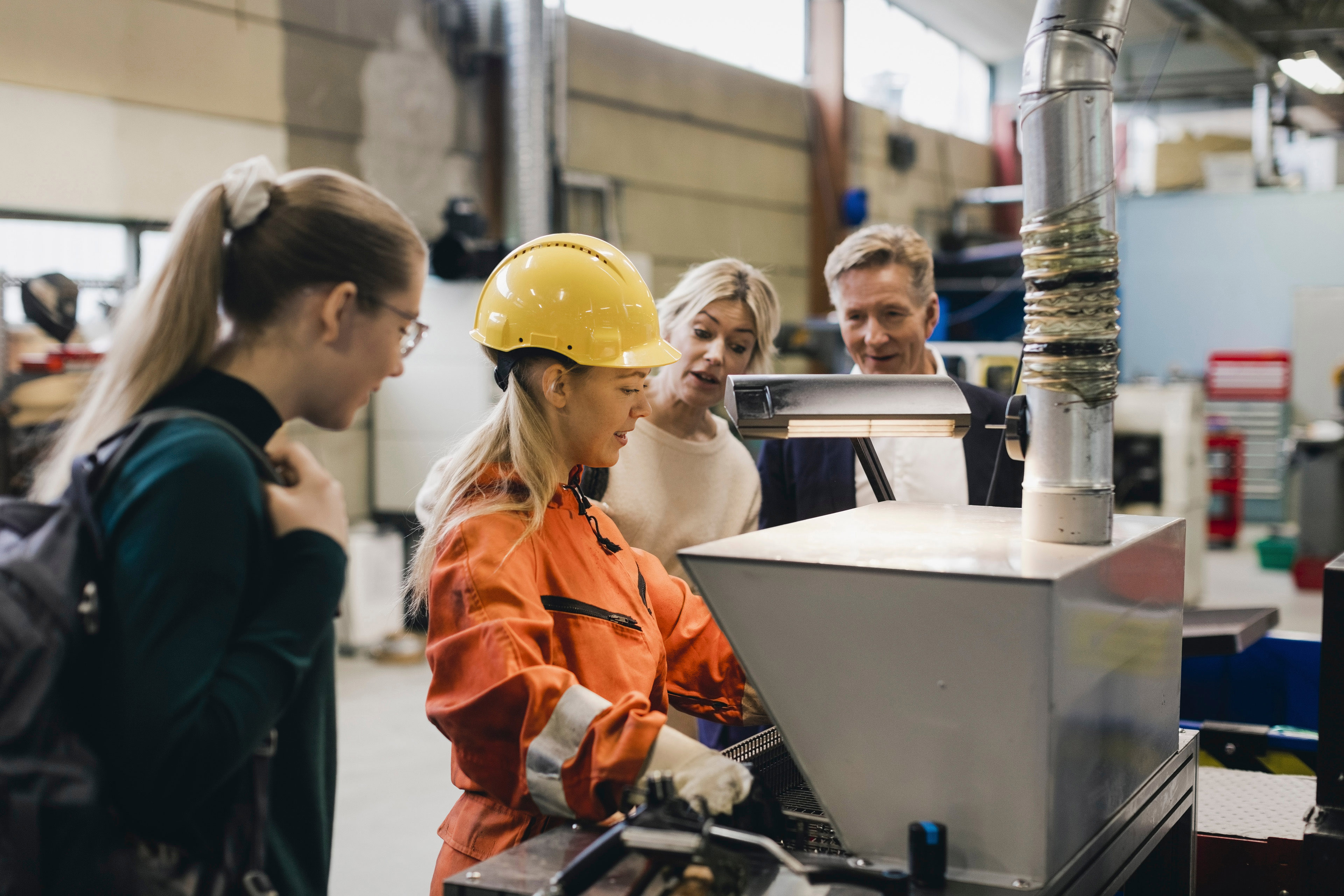 Family discussing factory machinery