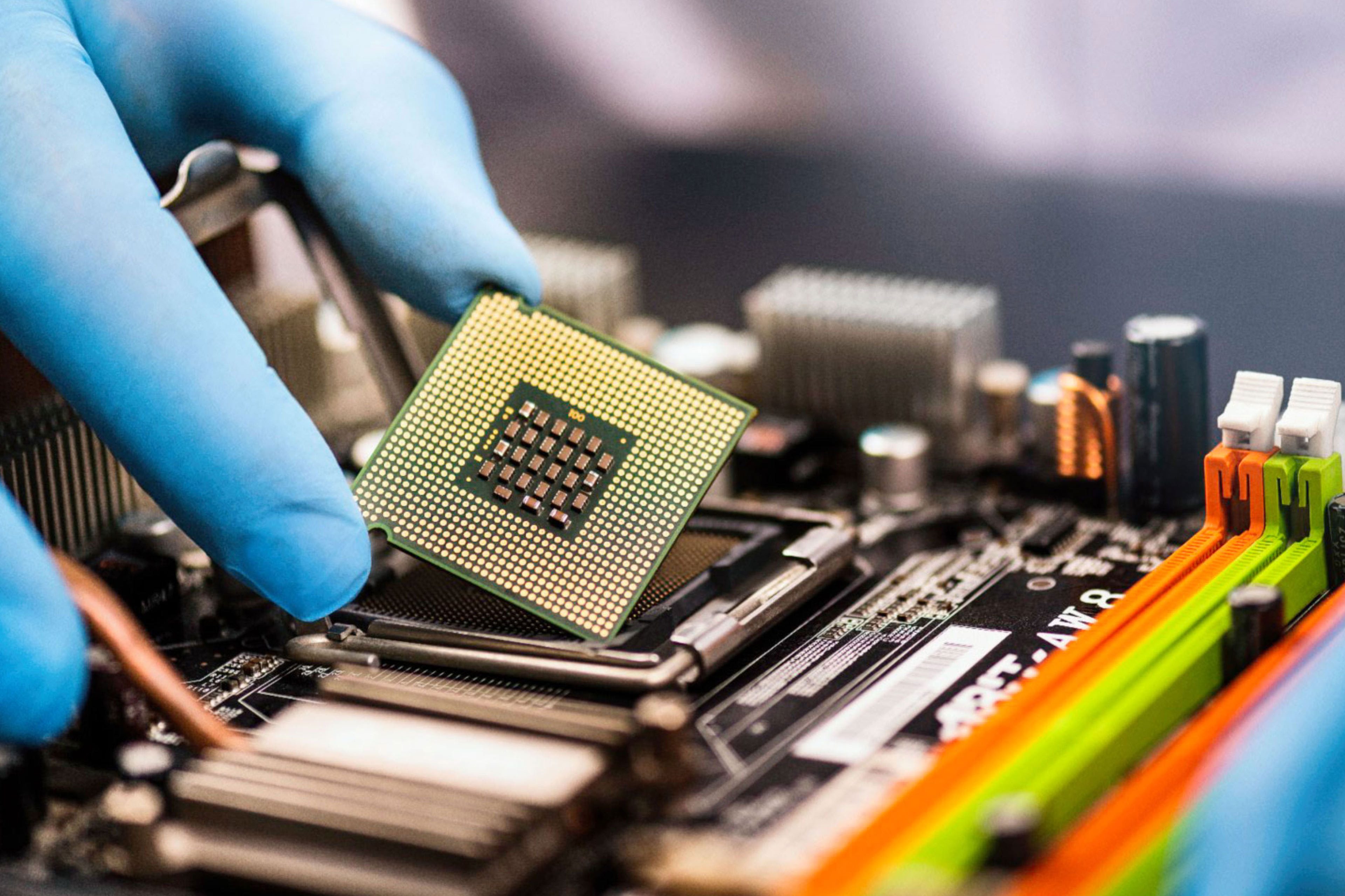 Gloved hand installing a computer chip