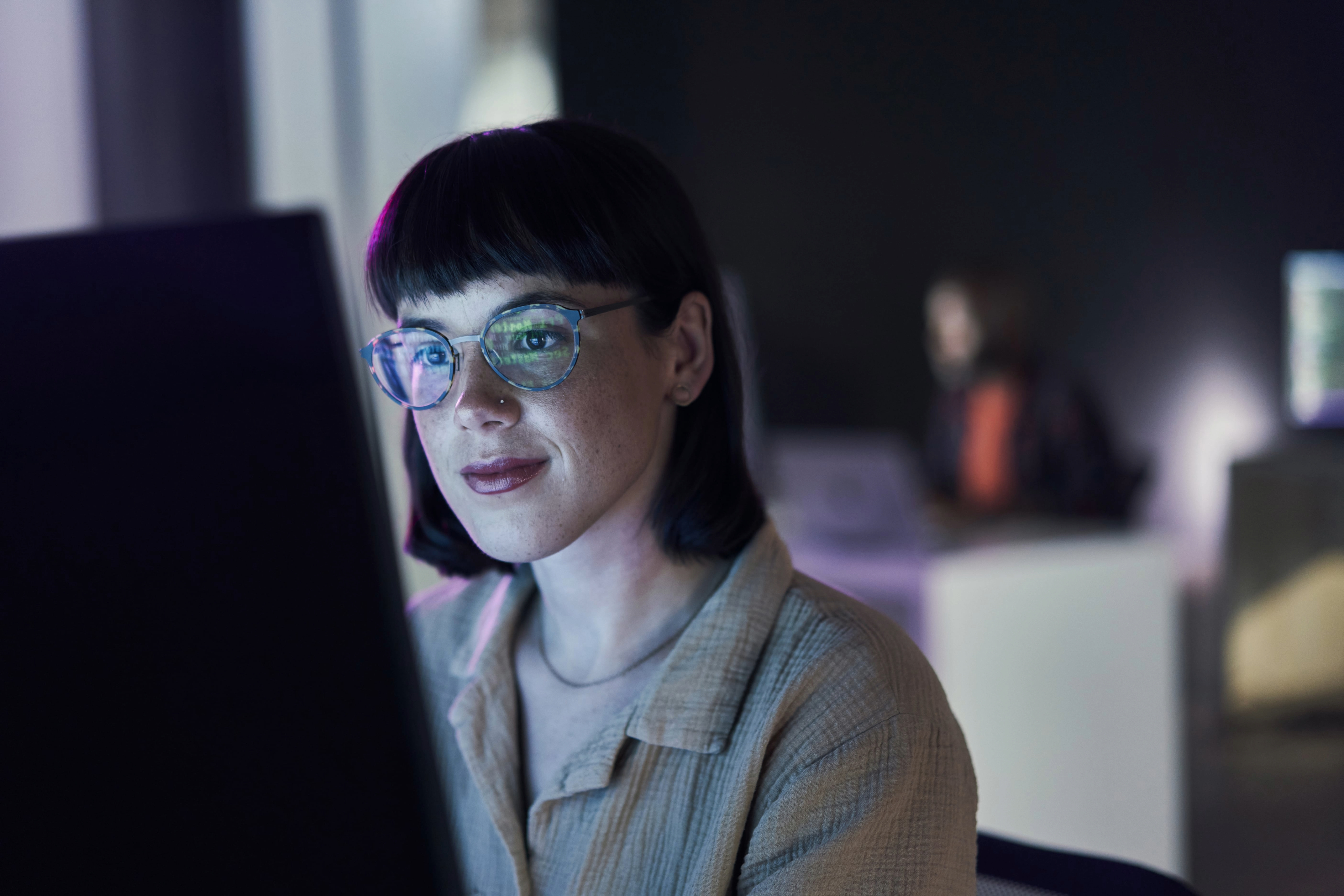 Business woman, computer seo work and coding of young employee with blue light and glasses