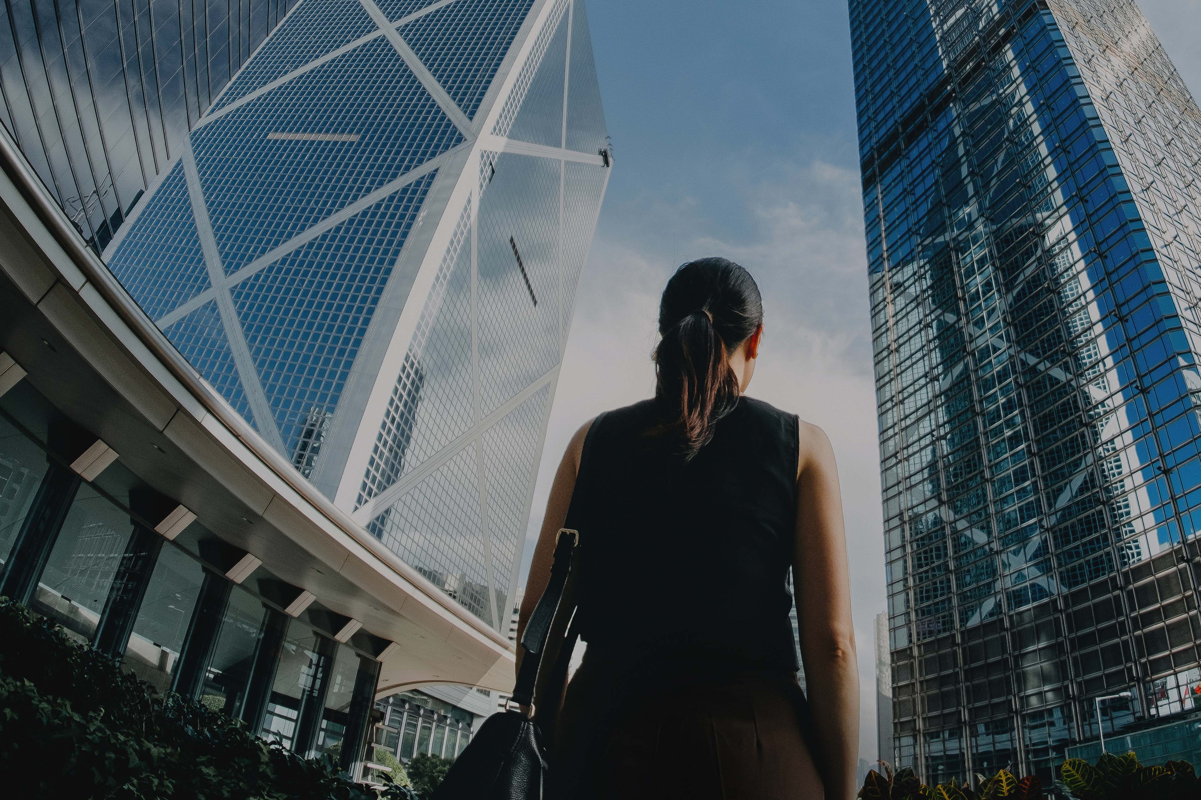 businesswoman looking at financial skyscrapers in Hong Kong